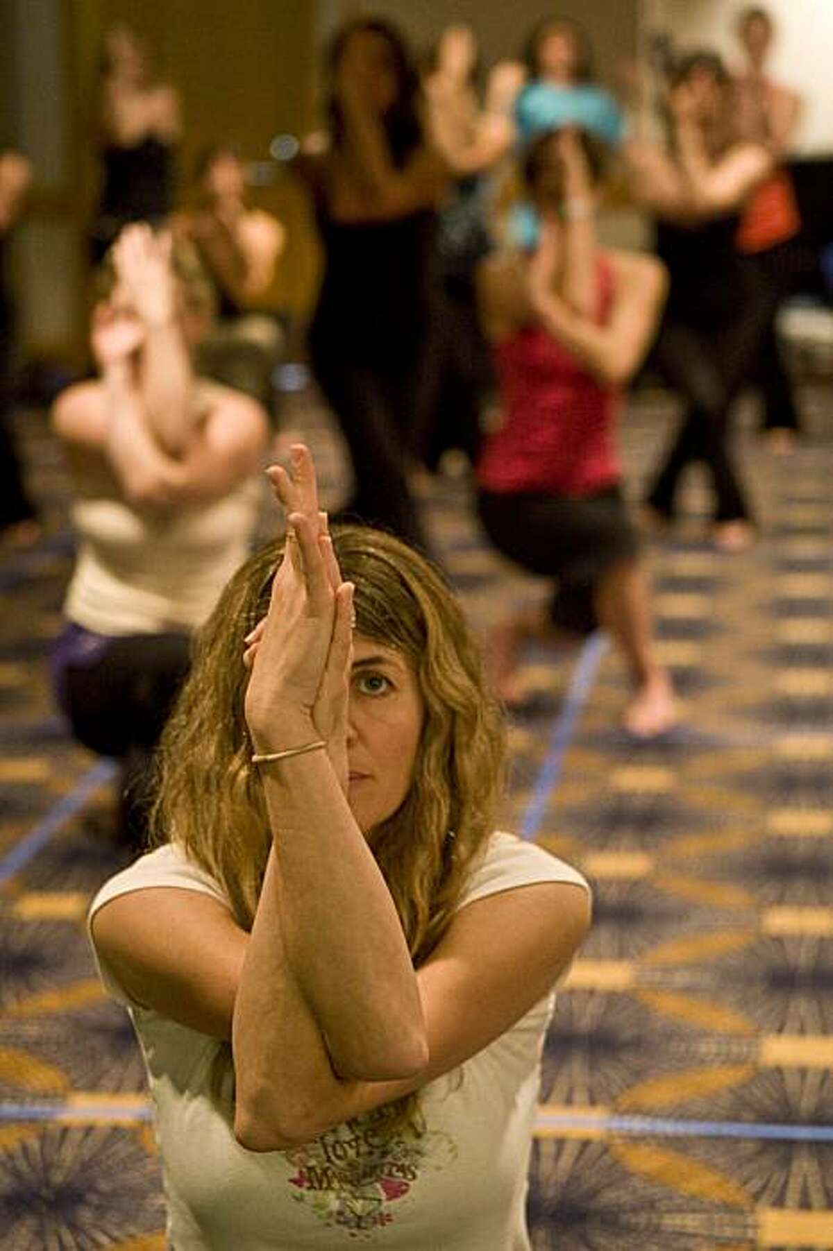 Lisa Rueff, first time participant in shadow yoga class lead by Scott Blossom at the Yoga Conference, San Francisco, Calif. Saturday January 30, 2010