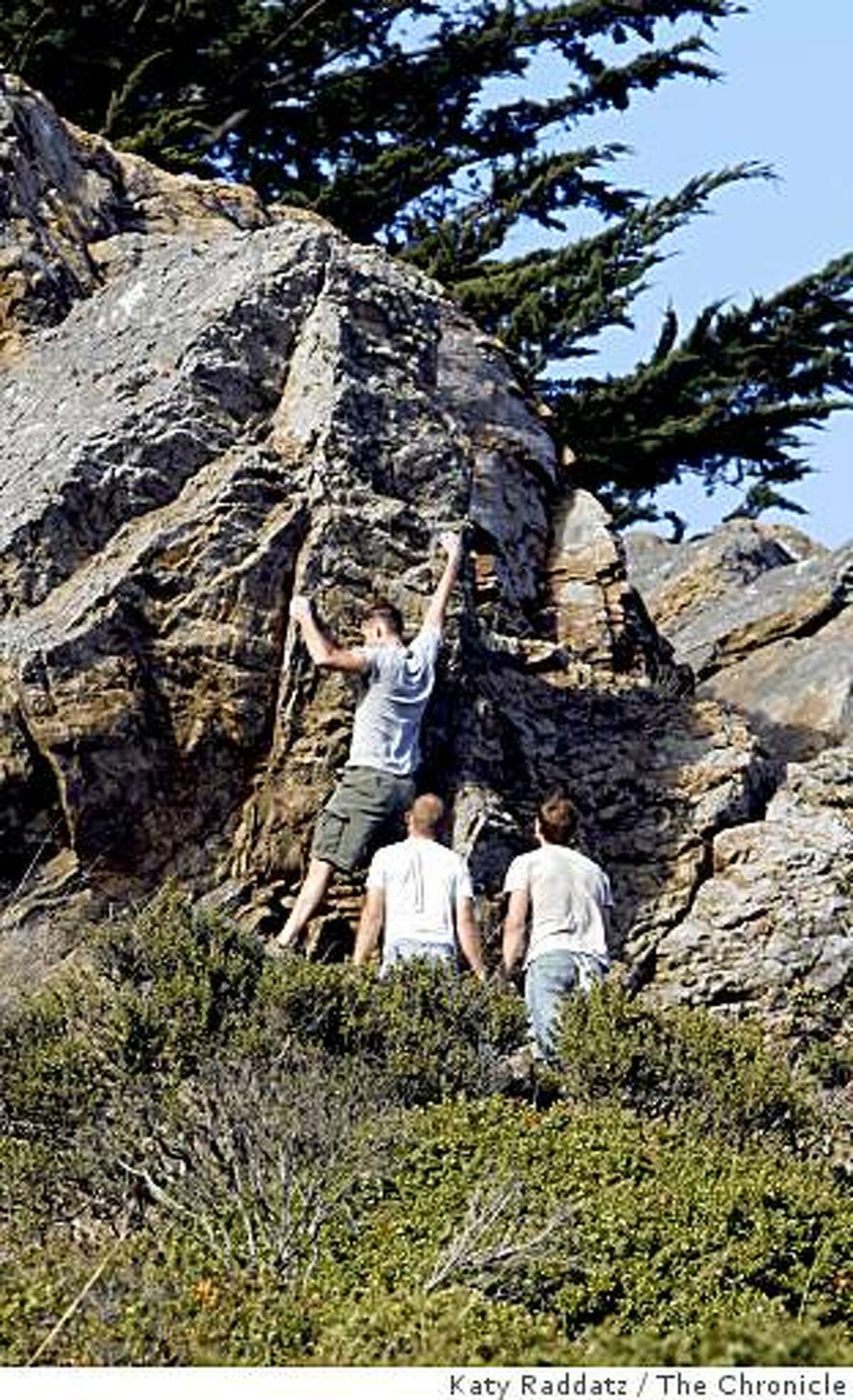 Rock climbers practice bouldering on one of the chert outcroppings in Glen Canyon, in San Francisco, Calif. Sunday, Aug. 3, 2008.