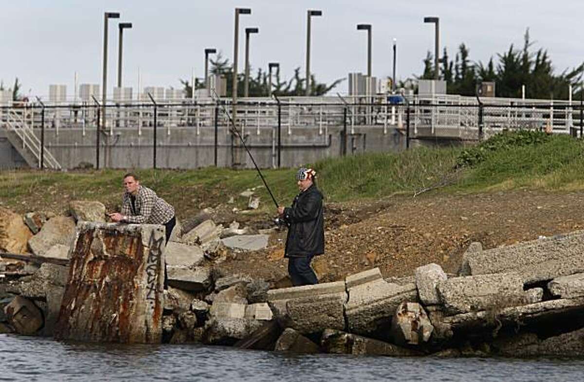 A man goes fishing along the shoreline in front of the Point Isabel wet weather facility managed by EBMUD in Richmond, Calif., on Thursday, Jan. 28, 2010. The watchdog group San Francisco Baykeeper is concerned about the large amounts of partially treated rain water discharged into the bay from the facility.
