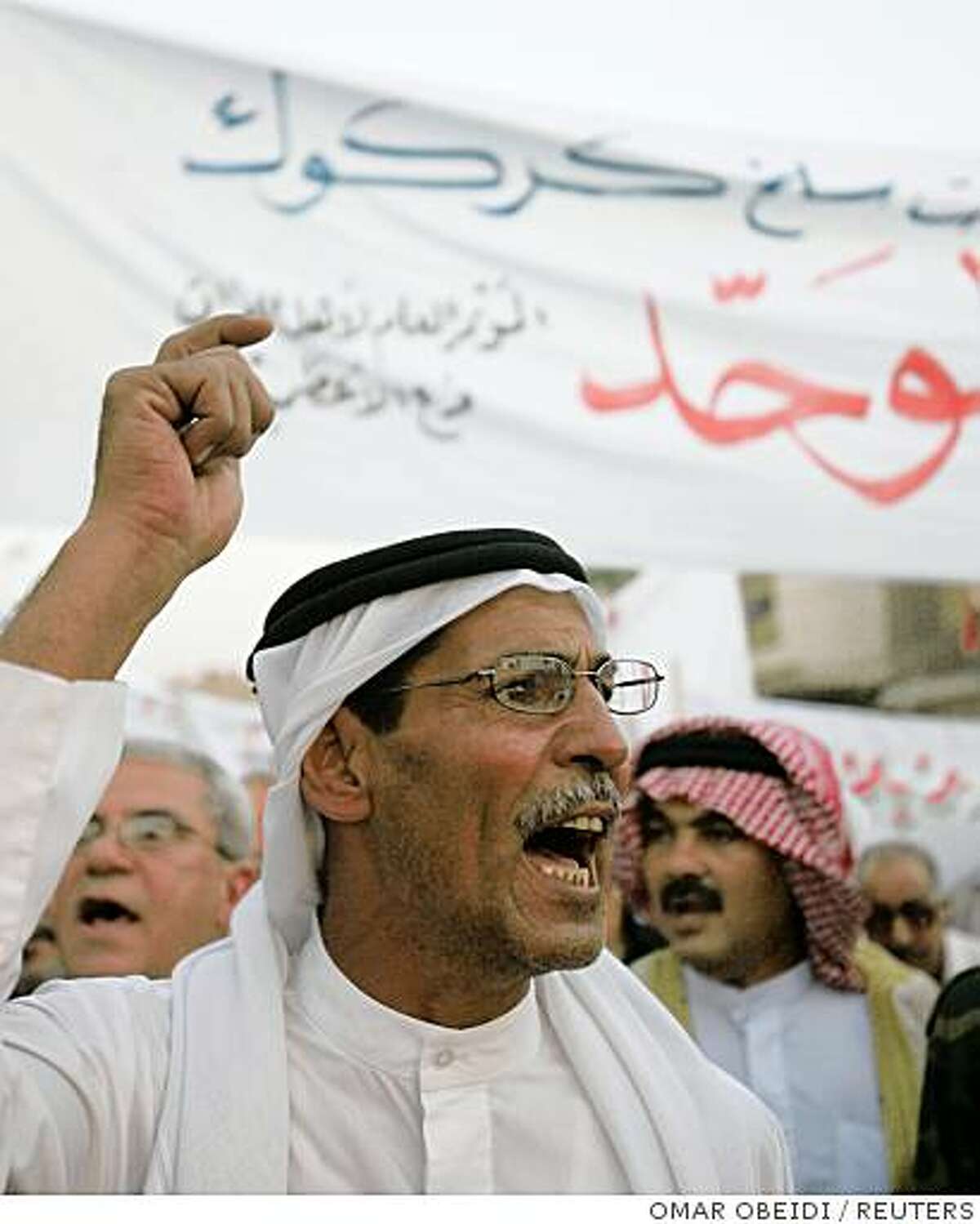 A demonstrator chants slogans during a protest in Baghdad's Adhamiya district August 4, 2008. Hundreds people took to the streets supporting the passage of the provincial council elections law, which includes an article postponing Kirkuk's elections. REUTERS/Omar Obeidi (IRAQ)