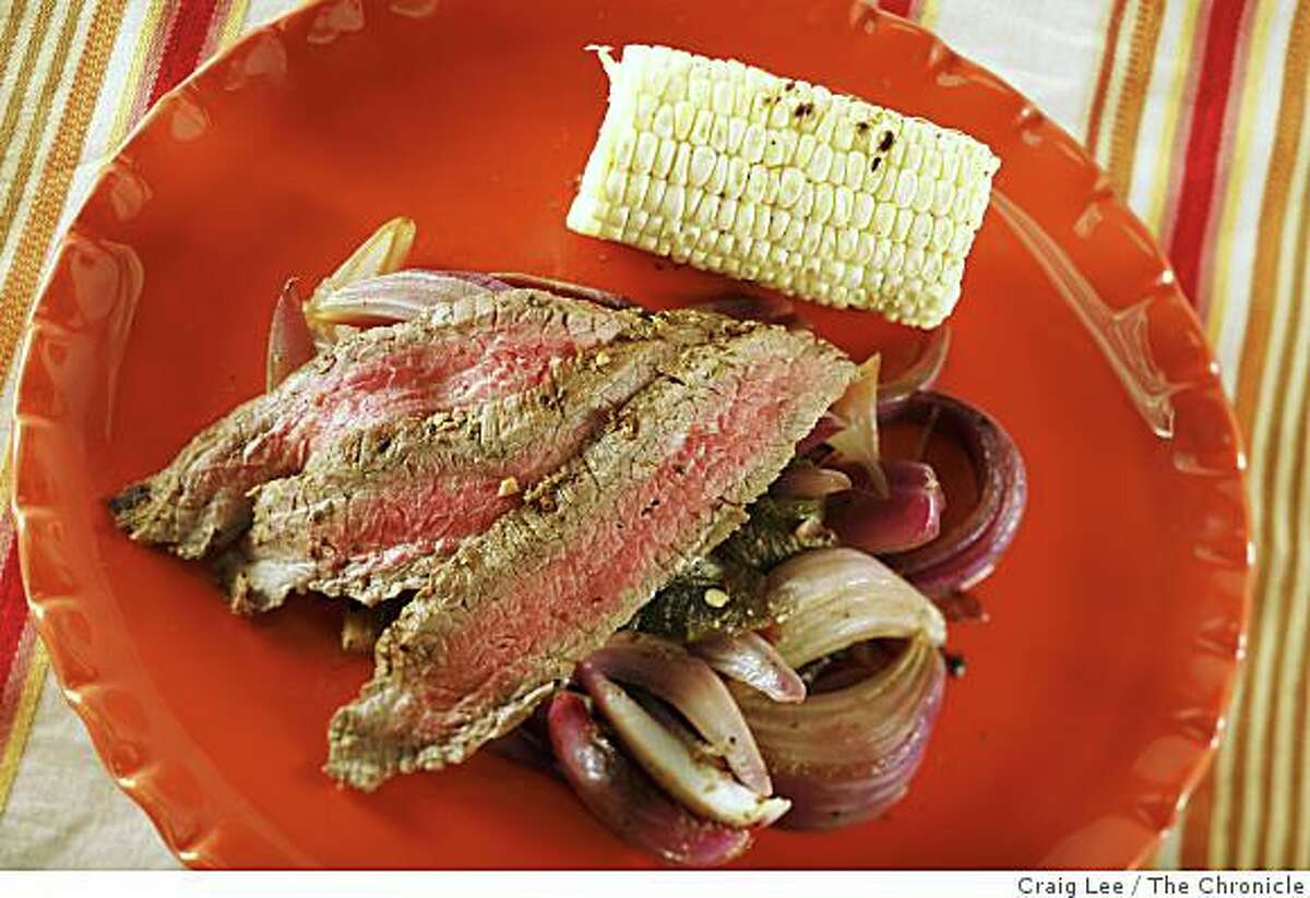 Grilled Flank Steak on a Bed of Grilled Poblanos and Roasted Onions in San Francisco, Calif., on July 17, 2008. Food styled by Emma Sullivan.Photo by Craig Lee / The Chronicle