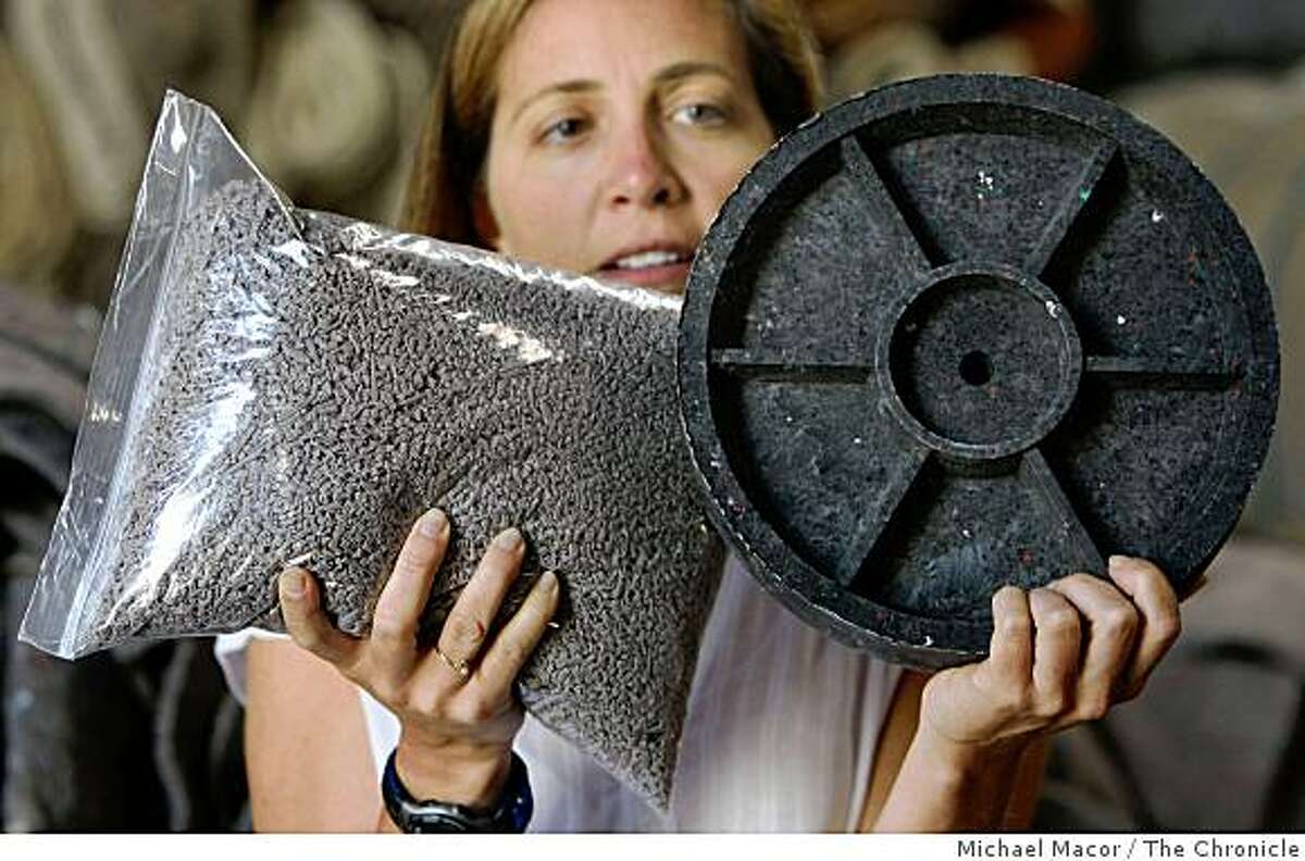 Ellen Raynor inside her Bayview warehouse, in San Francsico, Calif., on Tuesday July 22, 2008, with an example of what can be made from the processed recycled carpet, which is the finished product, small plastic pellets. Photo By Michael Macor/ The Chronicle