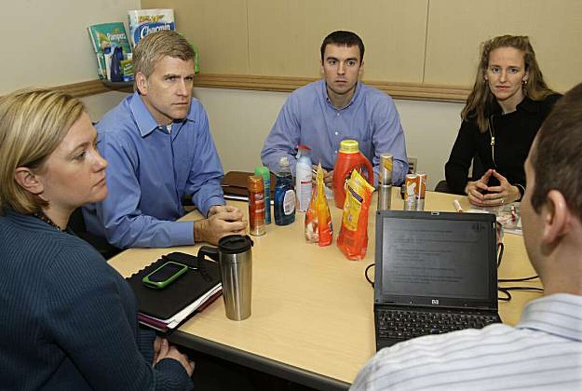 In this photo made Friday, Jan. 8, 2010, Procter & Gamble Co. employees, from left, Mandy Treeby, Kirk Perry, vice president for North America, Dave Brenner, and Suzanne Watson, listen to John McFarland, at a meeting on online retail sale in Cincinnati. P&G is ready to begin testing an online retail site that will enable shoppers to buy from the household portfolio of P&G.