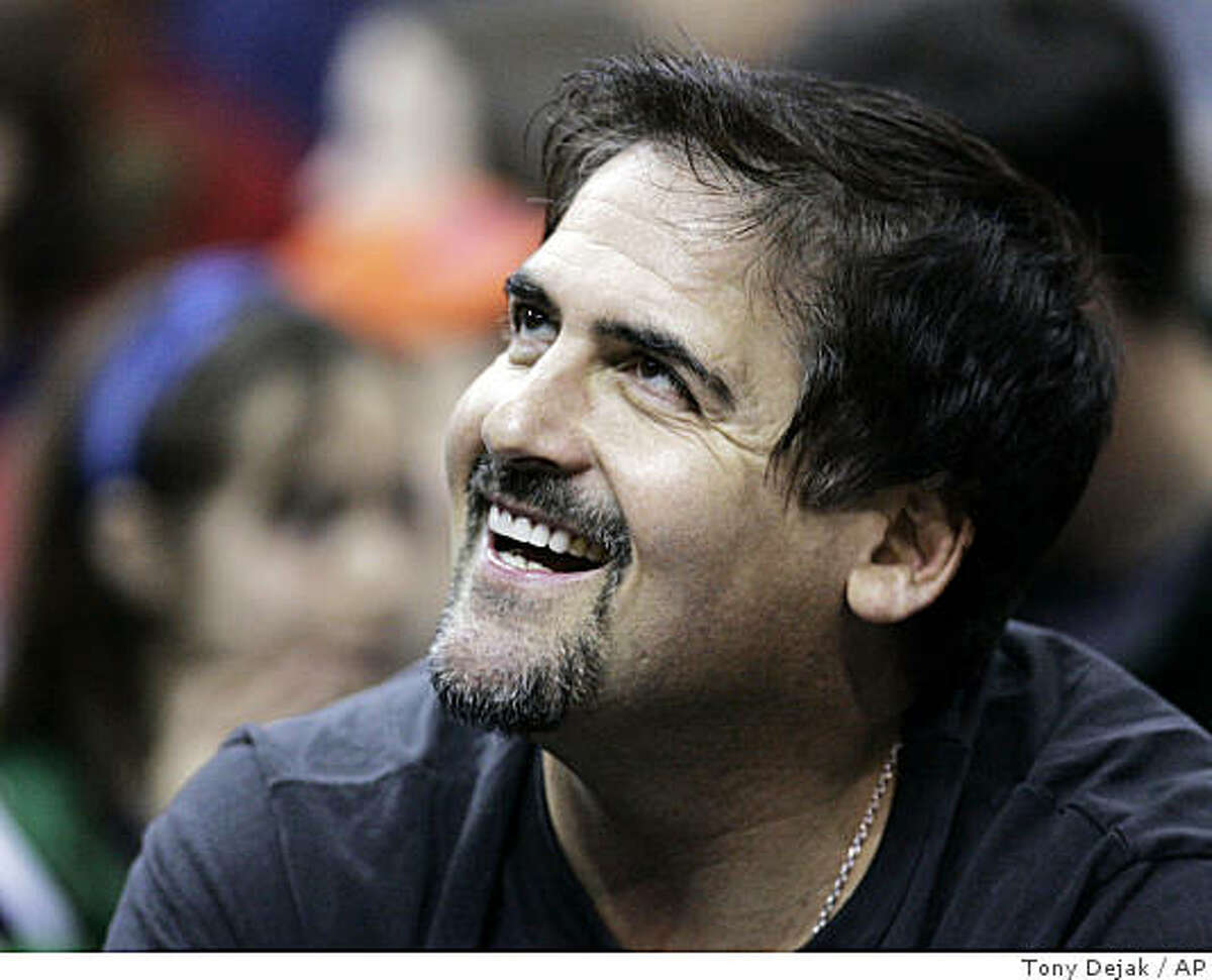 ** FILE ** Dallas Mavericks owner Mark Cuban smiles as the Mavericks play the Cleveland Cavaliers during an NBA basketball game in Cleveland in this March 21, 2007, file photo. Cuban said in a published report Friday, July 13, 2007, that he has submitted to Major League Baseball last week an application to purchase the Chicago Cubs (AP Photo/Tony Dejak) Ran on: 07-22-2007