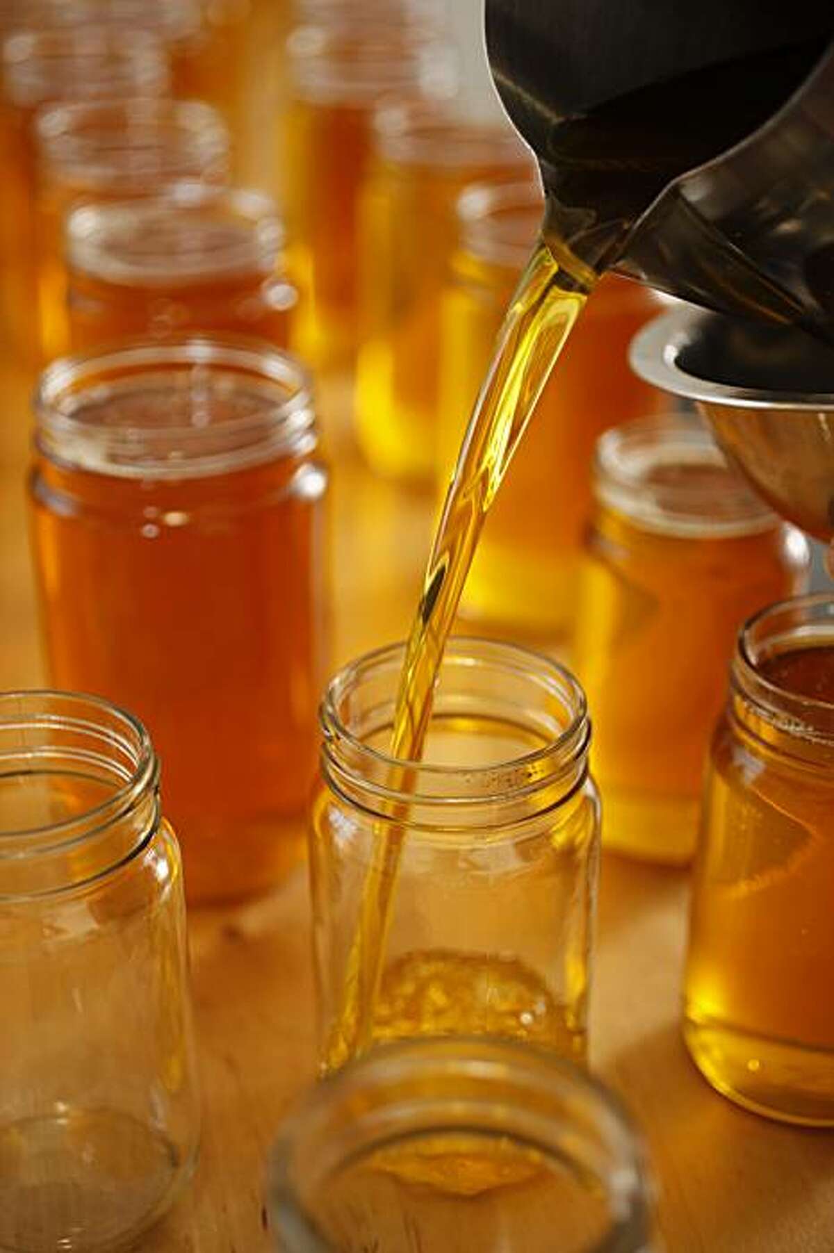 Ancient Organics, which produces homemade ghee in Richmond, Calif., on December 31, 2009. Freshly cooked ghee being poured into glass jars for distribution.
