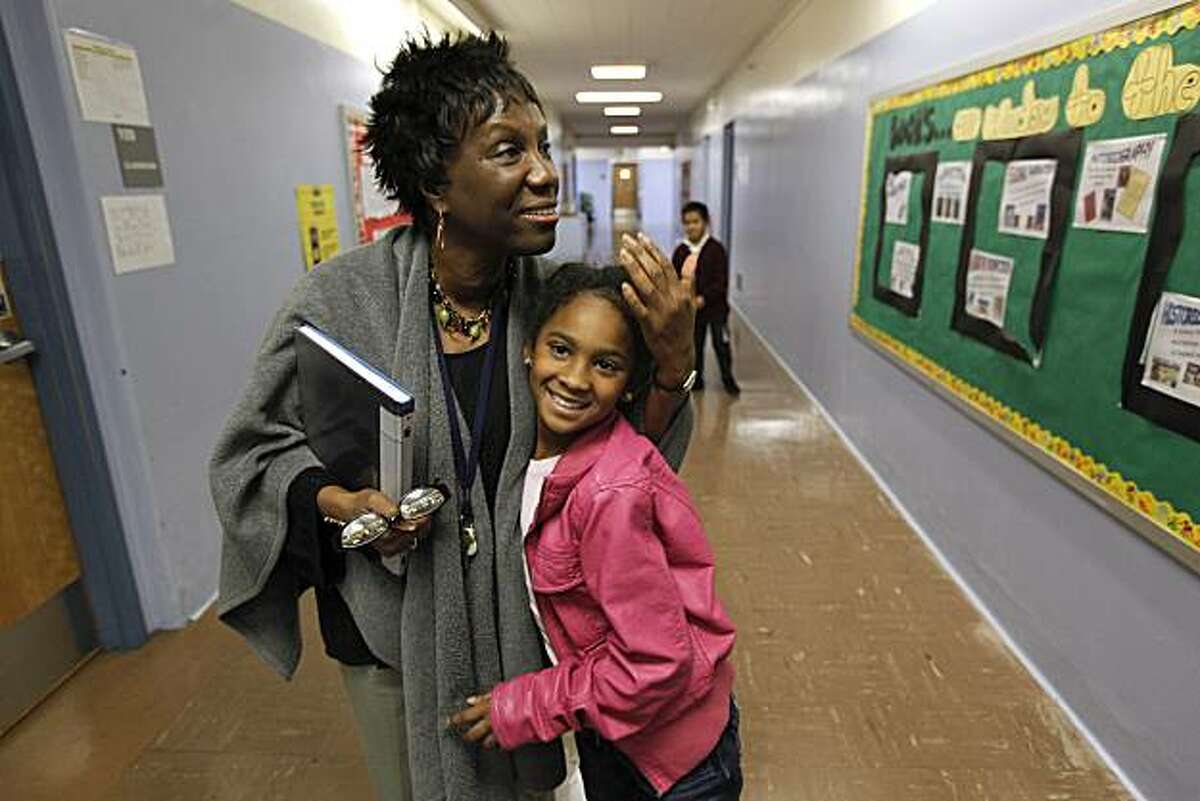 Imani Cooley, on Thursday January 7, 2010, hugs 2nd grader Jada Woodson in the hallway of her school, Cooley is in her first year as principal of Macolm X Academy Elementary School in Hunters Point, San Francisco, Calif. She shares her thoughts about the "Race to The Top" education program, which aims to turn around schools but principals like her have their own ideas of what it takes.