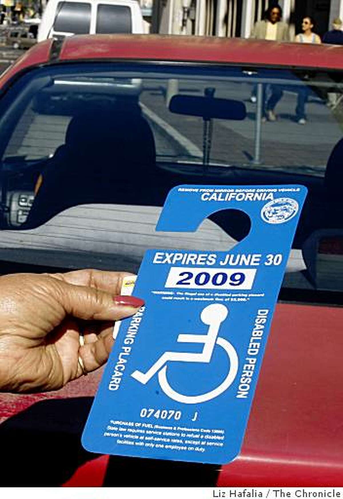 Eufrencia Lactaoeu,72 years old, shows her disabled placard while parked on Mission St. between 5th and 6th streets.