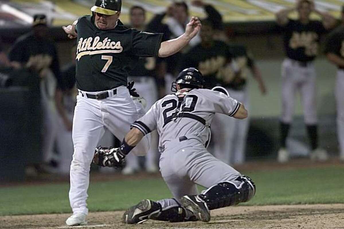 ATHLETICS21-C-13OCT01-SP-CG --- Oakland Athletics' designated hitter, Jeremy Giambi, was called out on this controversial play that would've scored the tying run at home plate in the bottom of the seventh inning against the New York Yankees at Network Associates' Coliseum on Saturday, October 13, 2001. New York catcher is Jorge Posada. (Photo by Carlos Avila Gonzalez/The San Francisco Chronicle)