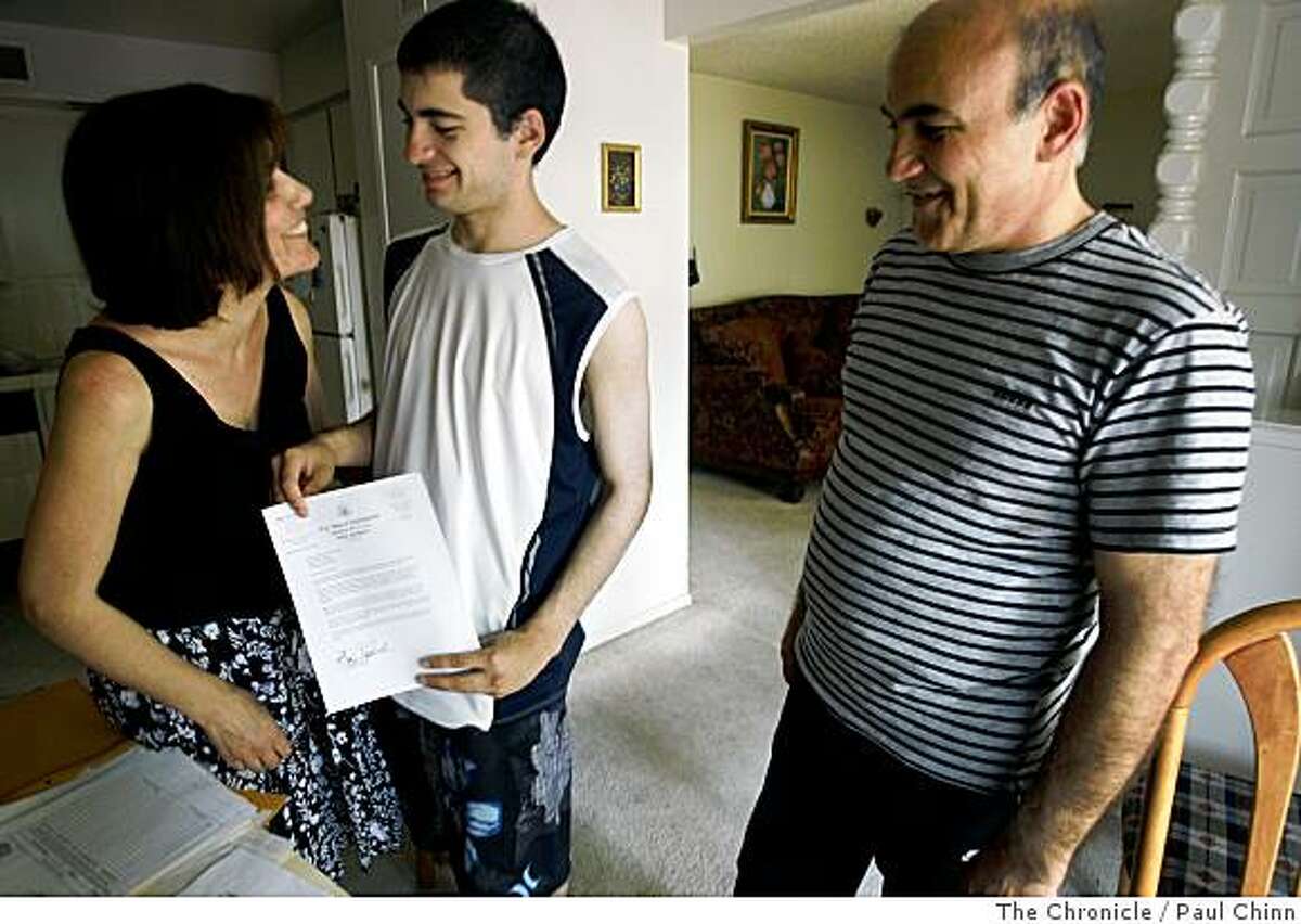 Asmik Karapetian, left, son Arthur, center, and husband Ruben Mkoian smile as they look at Sen. Dianne Feinstein's letter of support at their home in Fresno, Calif., on Thursday, June 26, 2008. The Armenian family immigrated to the United States about 16 years ago and may be deported by Immigrations and Customs Enforcement if a bill introduced Feinstein fails to pass.Photo by Paul Chinn / The Chronicle