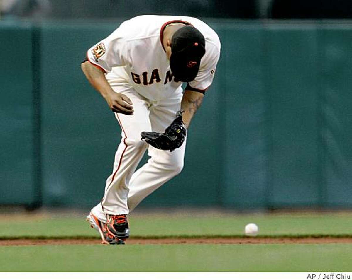 San Francisco Giants' Jose Castillo makes an error on a ground ball hit by Chicago Cubs' Ronny Cedeno in the second inning of a baseball game in San Francisco, Monday, June 30, 2008. (AP Photo/Jeff Chiu)