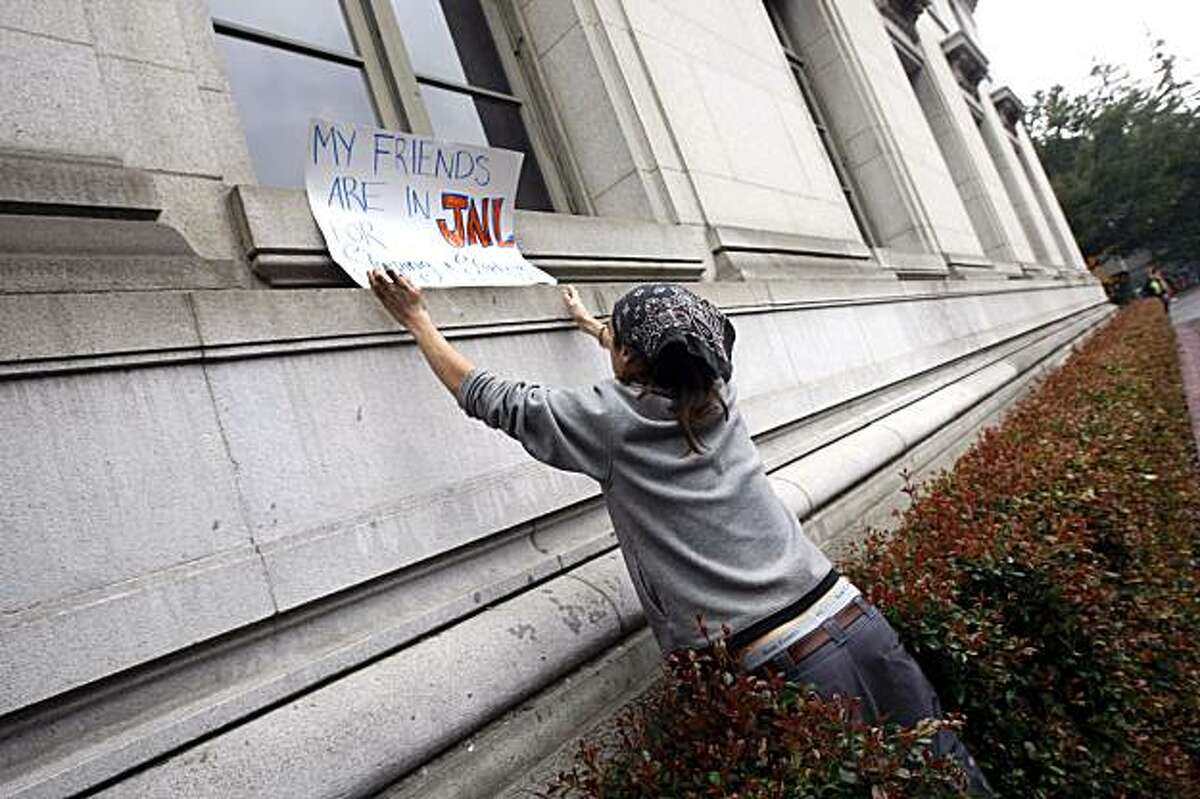 Dan Scott places his protest sign on a window ledge of the chancellor's offices in California Hall Friday Dec 11, 2009. The students are protesting the arrest of 65 fellow students that had occupied Wheeler Auditorium until an early raid.