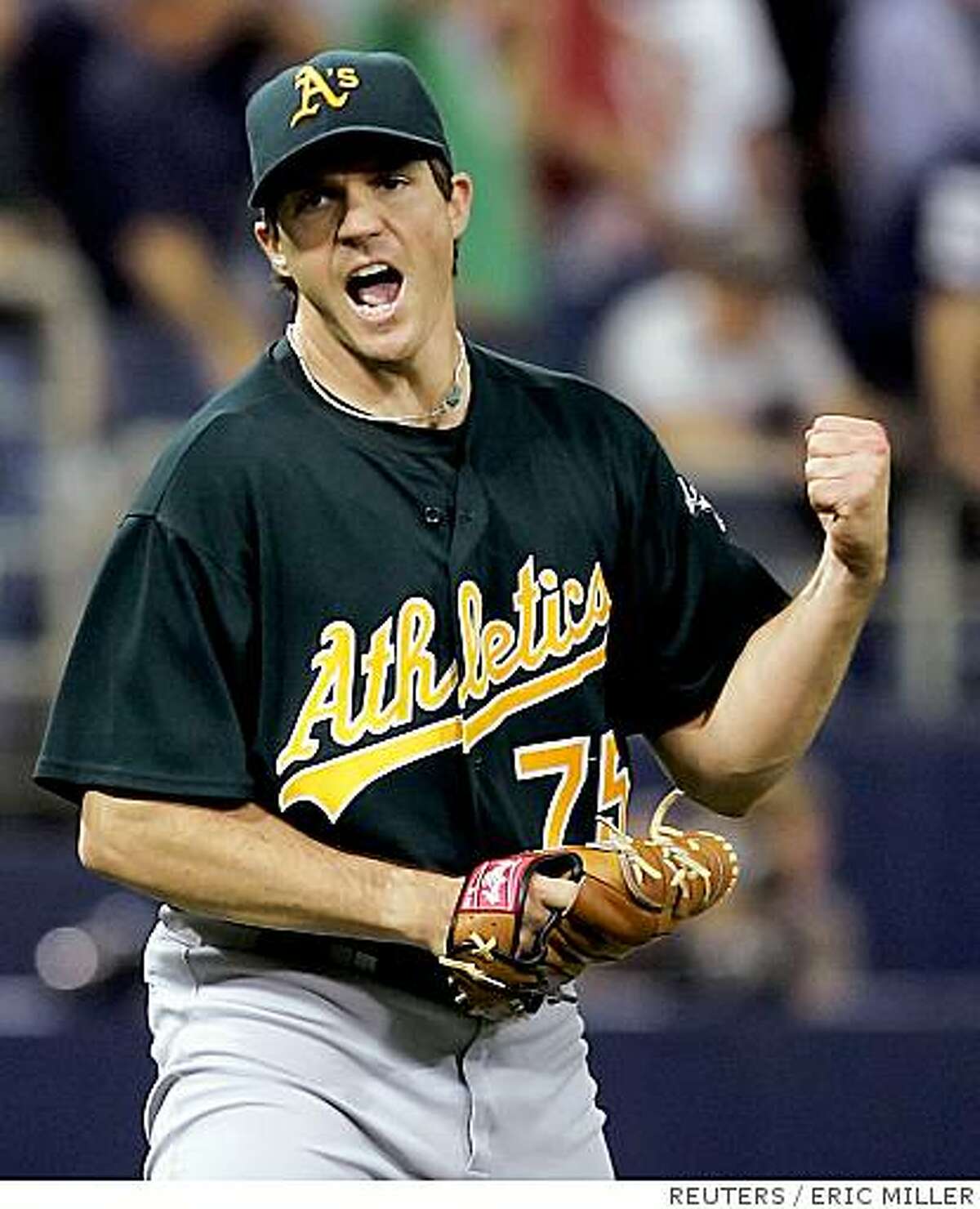 Oakland Athletics starting pitcher Barry Zito reacts to retiring Minnesota Twins batter Joe Mauer to end the eighth inning of Game 1 of the American League Divisional Series in Minneapolis, Minnesota in this October 3, 2006 file photo.