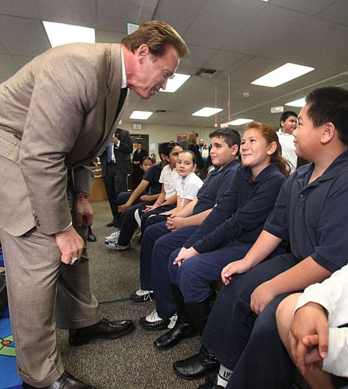 Gov. Arnold Schwarzenegger talks with fifth-grader Emyly Lua, 10, after holding a news conference at Noralto Elementary School in Sacramento, Calif., Tuesday, Dec. 8, 2009. Schwarzenegger visited the school where he called on the Legislature to approve a education reform package. (AP Photo/Rich Pedroncelli)