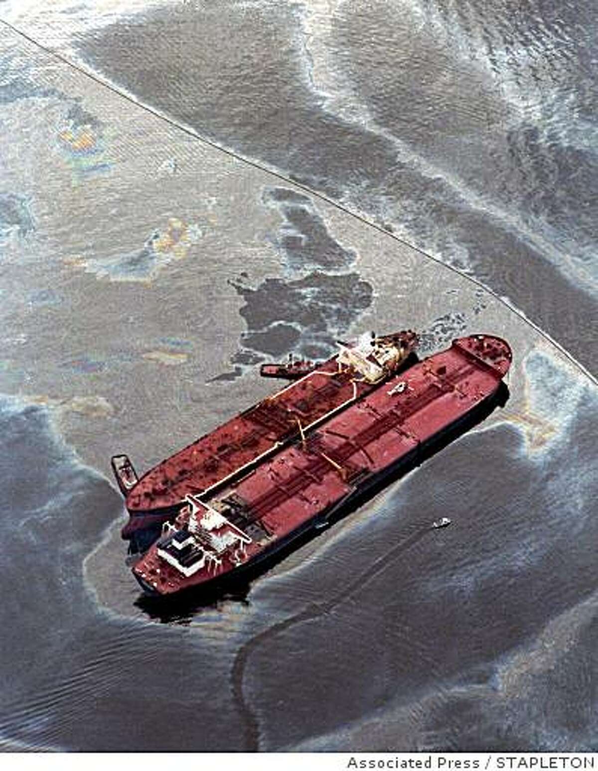 The smaller Exxon Baton Rouge attempts to off-load crude oil March 26,1989, from the Exxon Valdez, aground in Alaska's Prince William Sound. The tanker spilled 11 million gallons of crude in America's worst oil spill. (AP Photo/Stapleton)