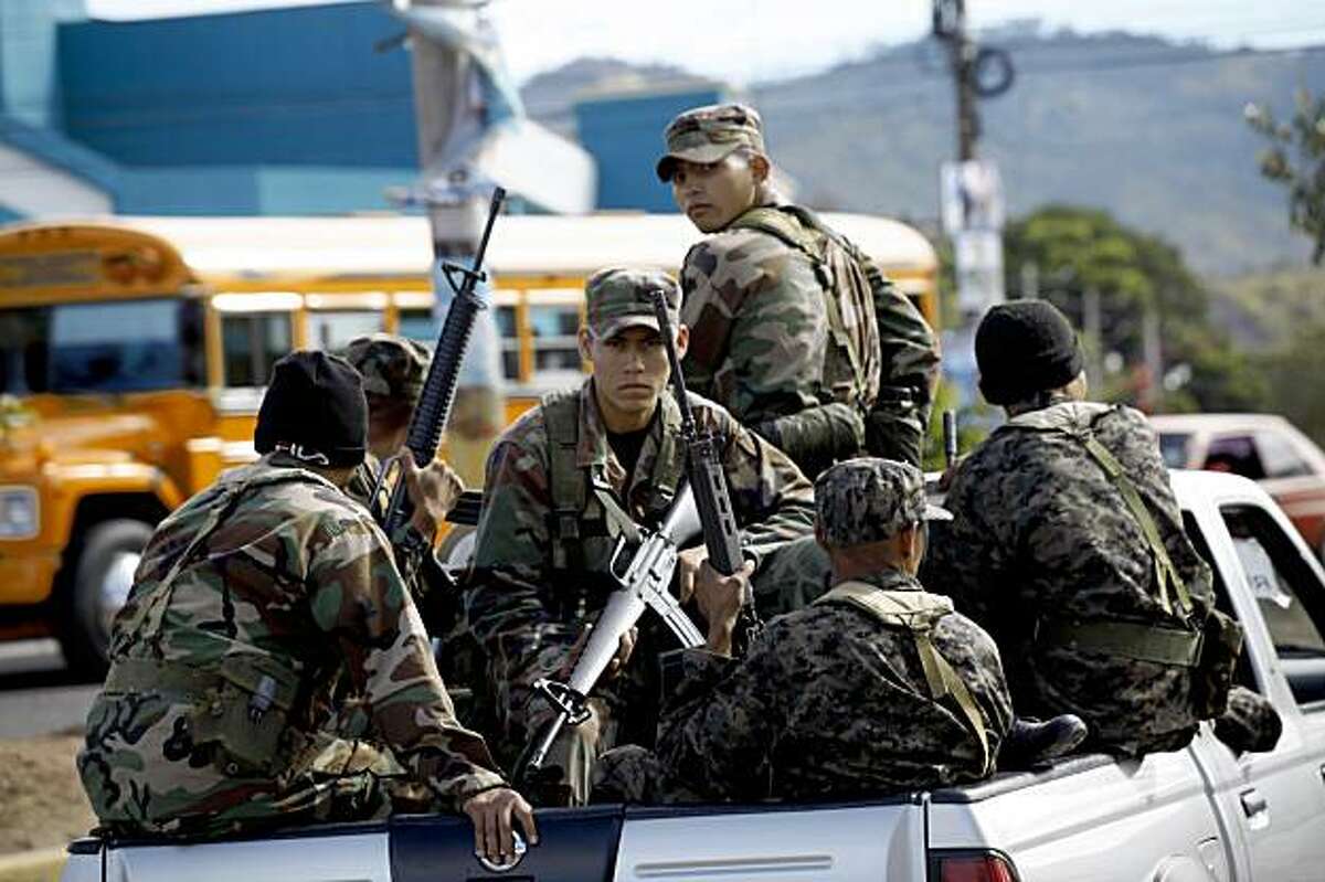 Soldiers guard ballots on their way to a polling station in Tegucigalpa, Saturday, Nov. 28, 2009. With President Manuel Zelaya, who was ousted in a military coup last June, still holed up in the Brazilian embassy, voters will choose a new president Nov. 29 from the political establishment that has dominated Honduras for decades. (AP Photo/Rodrigo Abd)