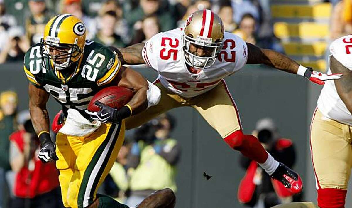 Green Bay Packers' Ryan Grant, left, breaks away from San Francisco 49ers' Tarell Brown on a run during the first half of an NFL football game Sunday, Nov. 22, 2009, in Green Bay, Wis. (AP Photo/Jim Prisching)