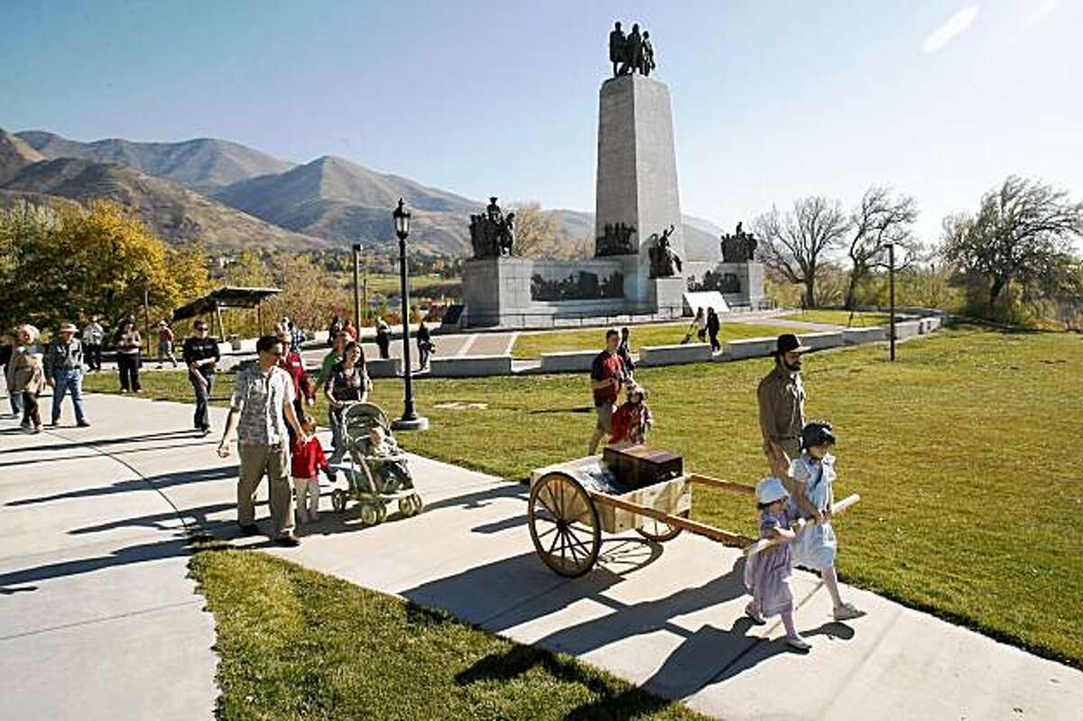 Lucy Danzig, 4, Eliza Danzig, 9, and Peter Danzig pull a replica of a pioneer handcart filled with petitions to Mormon church leaders, Wednesday, Nov. 4, 2009, in Salt Lake City. The Foundation for Reconciliation delivered more than 2,000 petition signatures to The Church of Jesus Christ of Latter-day Saints asking them to reconsider their policies and political activism against same-sex marriage. (AP Photo/The Salt Lake Tribune, Chris Detrick) ** DESERT NEWS OUT, MAGS OUT, NO SALES. **