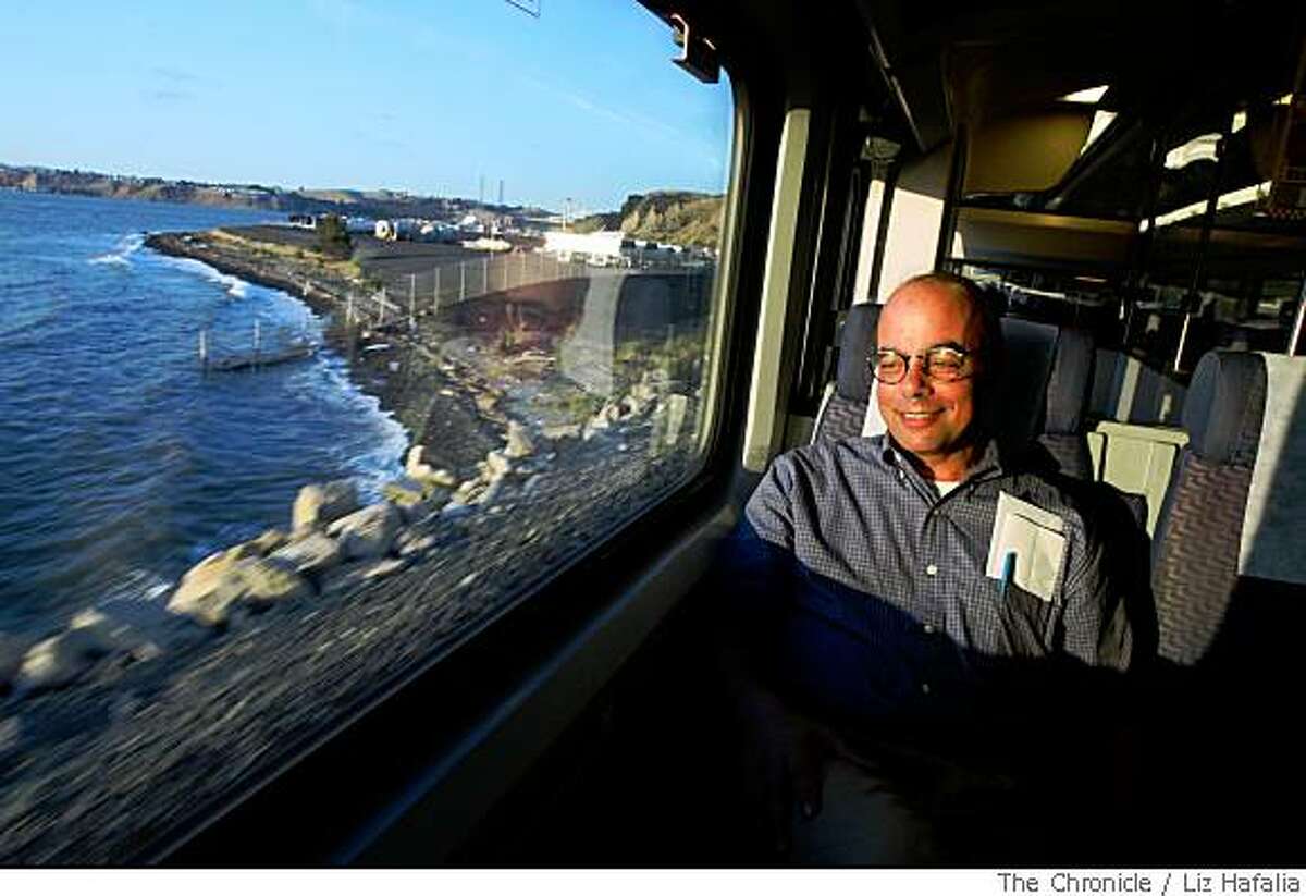 Jeff Magnin, professor from UC Davis, watching the sunset on the bay while riding the Capitol Corridor nearing the Richmond station on Thursday, May 29, 2008. The Chronicle