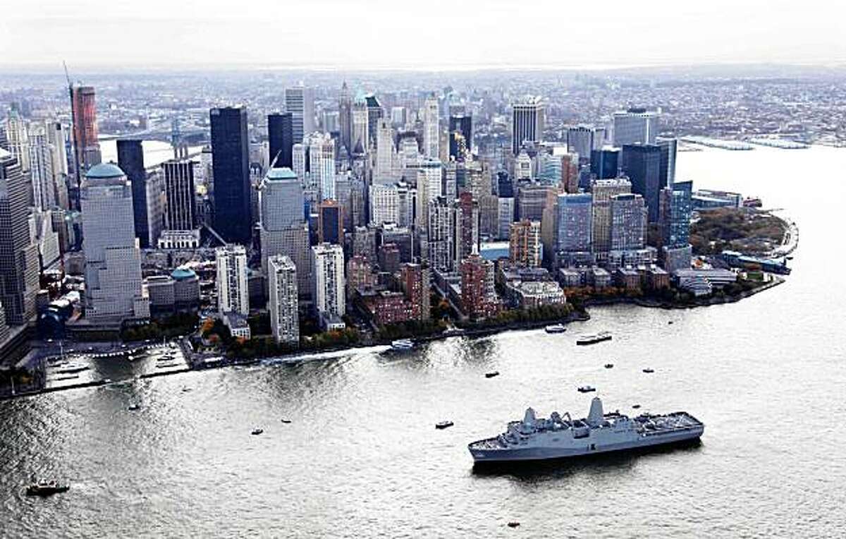 The new Navy assault ship USS New York, built with World Trade Center steel, passes lower Manhattan as it arrives Monday, Nov. 2, 2009 in New York. The World Trade Center construction site is at left. (AP Photo/Mark Lennihan)
