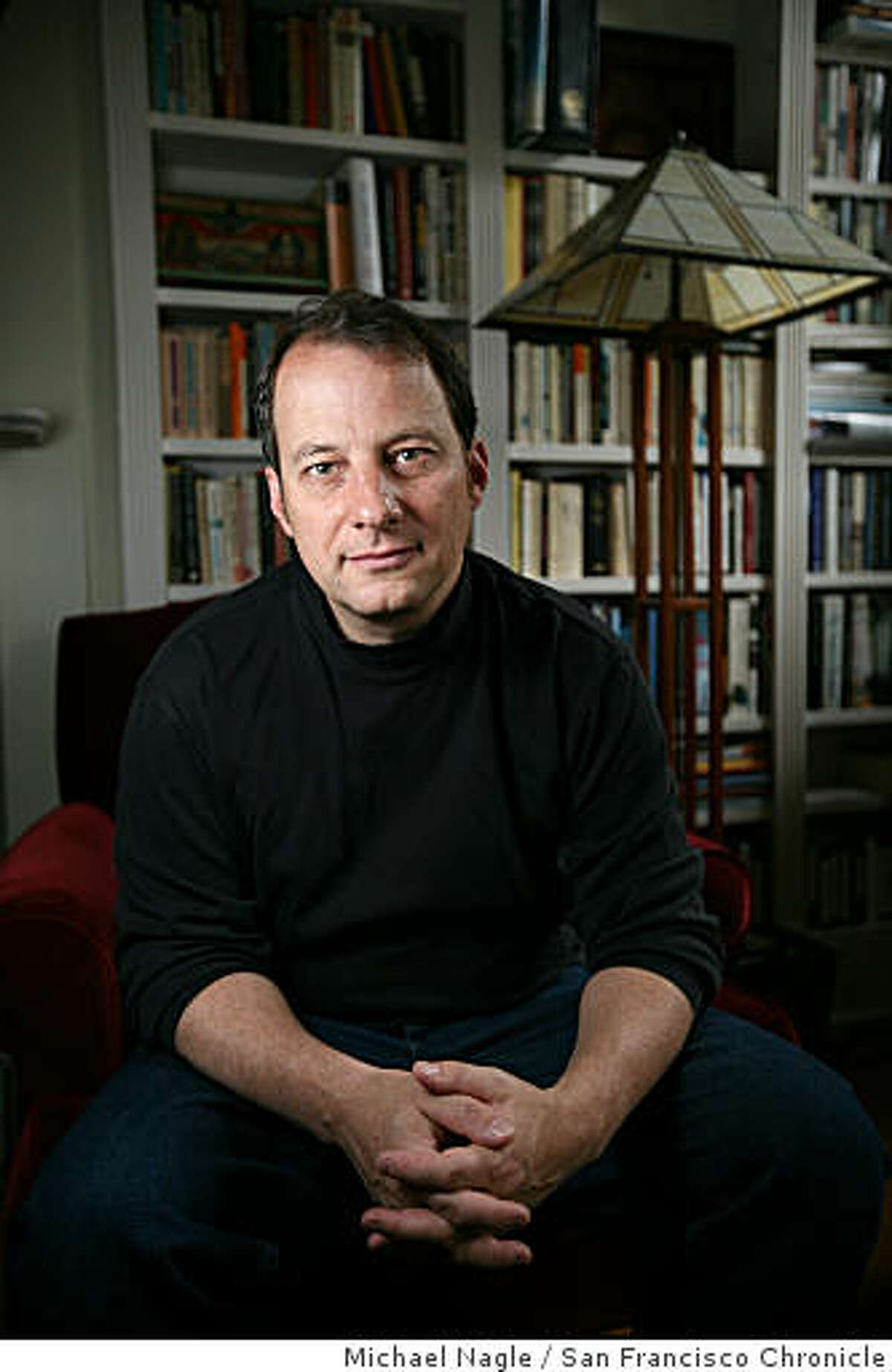 BROOKLYN, NY - MAY 09, 2008: Journalist and novelist George Packer poses in his Prospect Heights apartment on May 09, 2008 in Brooklyn, NY. For Packer, a staff writer for the New Yorker, writing runs in the family.