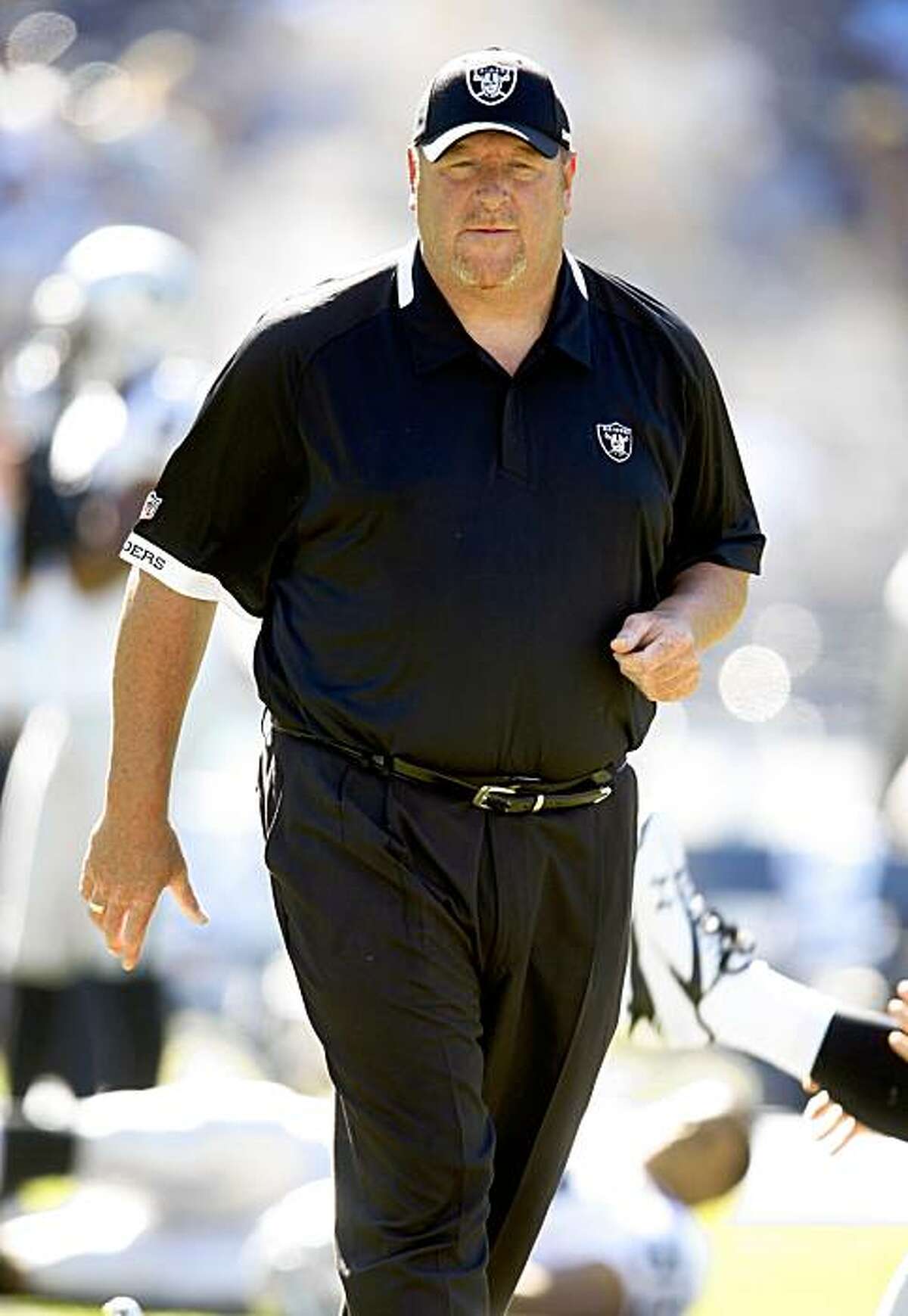 Oakland Raiders coach Tom Cable walks amongst his players during warm-ups prior to an NFL football game against the San Diego Chargers, Sunday, Nov. 1, 2009, in San Diego. (AP Photo/Chris Park)