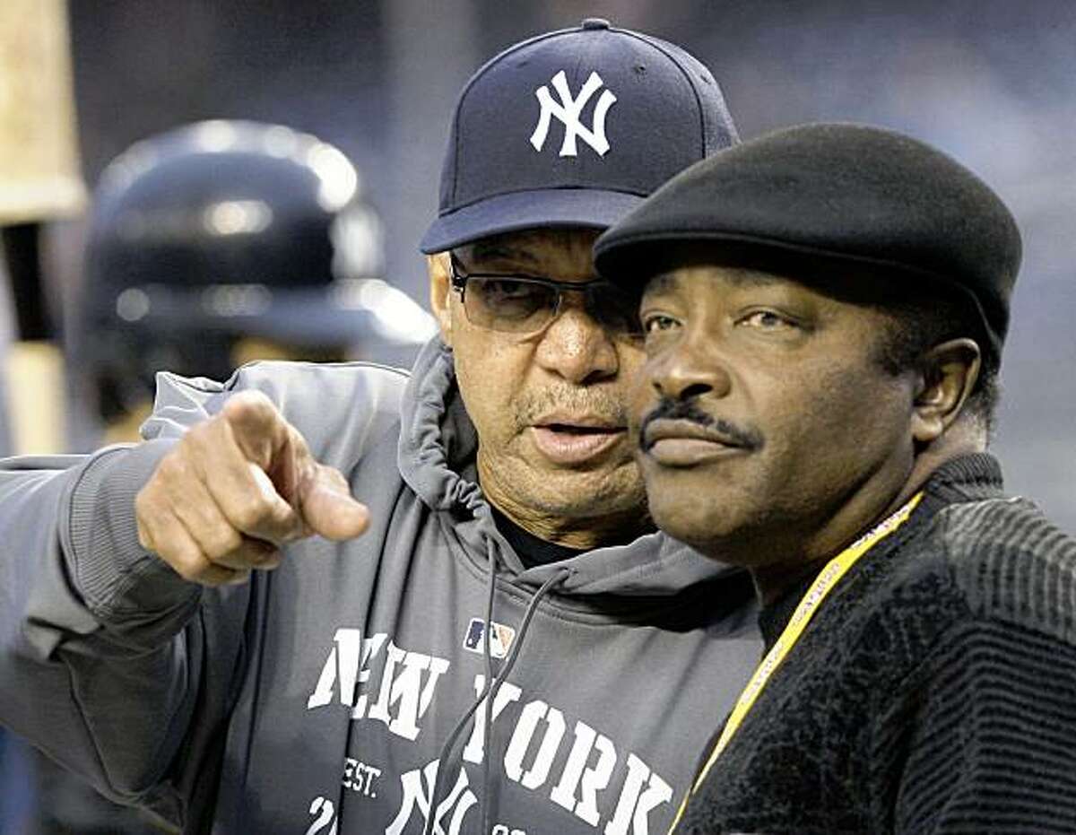 ** CORRECTS ID TO REGGIE JACKSON, NOT DAVE WINFIELD ** Former New York Yankees' Reggie Jackson, left, chats with MLB Hall of Famer and former Cinncinati Reds Joe Morgan before Game 2 of the American League Championship baseball series between the Yankees and the Los Angeles Angels Saturday, Oct. 17, 2009, in New York. (AP Photo/Elise Amendola)