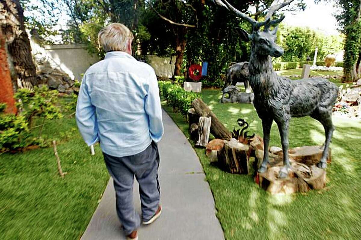 Bob Pritikin walks through the yard of his mansion in Glen Park.