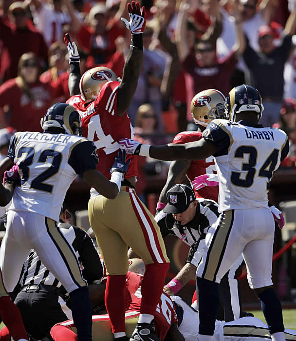 The 49ers' Michael Robinson celebrates the Rams' botched punt return recovered by Scott McKillop for a touchdown. The 49ers played the St. Louis Rams at Candlestick Park in San Francisco on Sunday.