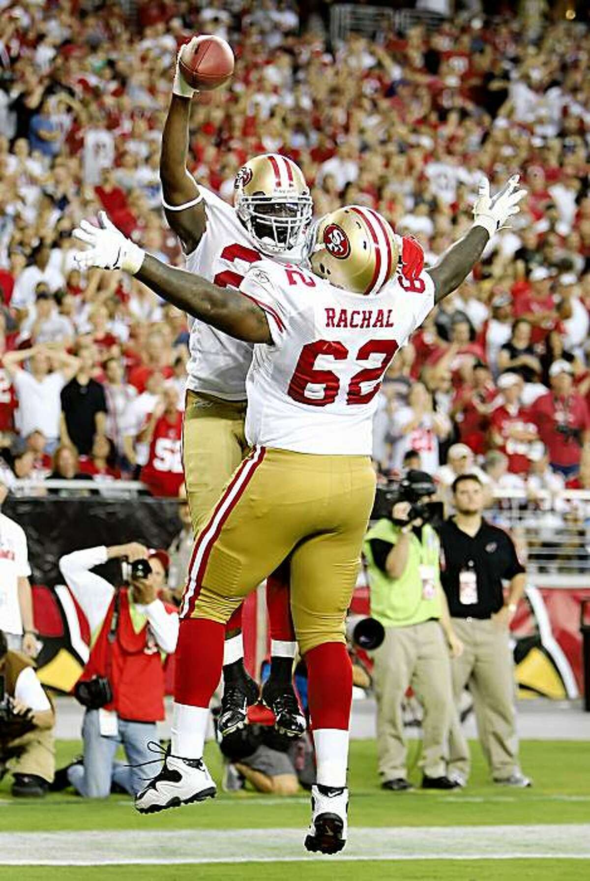 GLENDALE, AZ - SEPTEMBER 13: Running back Frank Gore #21 of the San Francisco 49ers celebrates with teammate Chilo Rachal #62 after Gore scored a 3 yard touchdown reception against the Arizona Cardinals during the NFL game at the Universtity of Phoenix Stadium on September 13, 2009 in Glendale, Arizona. The 49ers defeated the Cardinals 20-16. (Photo by Christian Petersen/Getty Images)