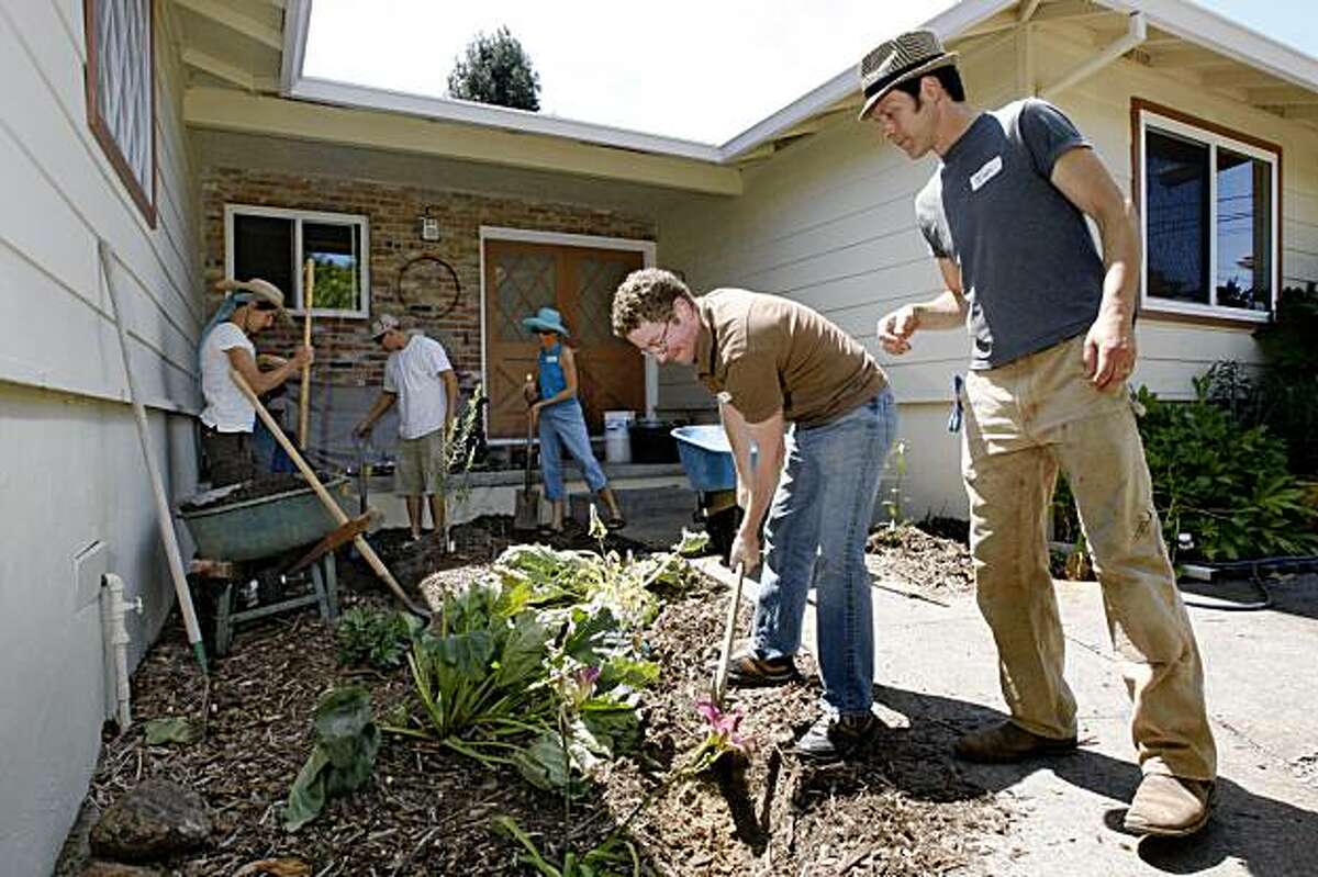 Ian Fratar (right, hat) gives Jubal Kessler (center) some instruction of how deep a pipe should be laid during a hands-on greywater workshop run by the "Greywater Guerrillas" an East Bay group dedicated to improving water re-use in Fairax Calif., on August 22, 2009.