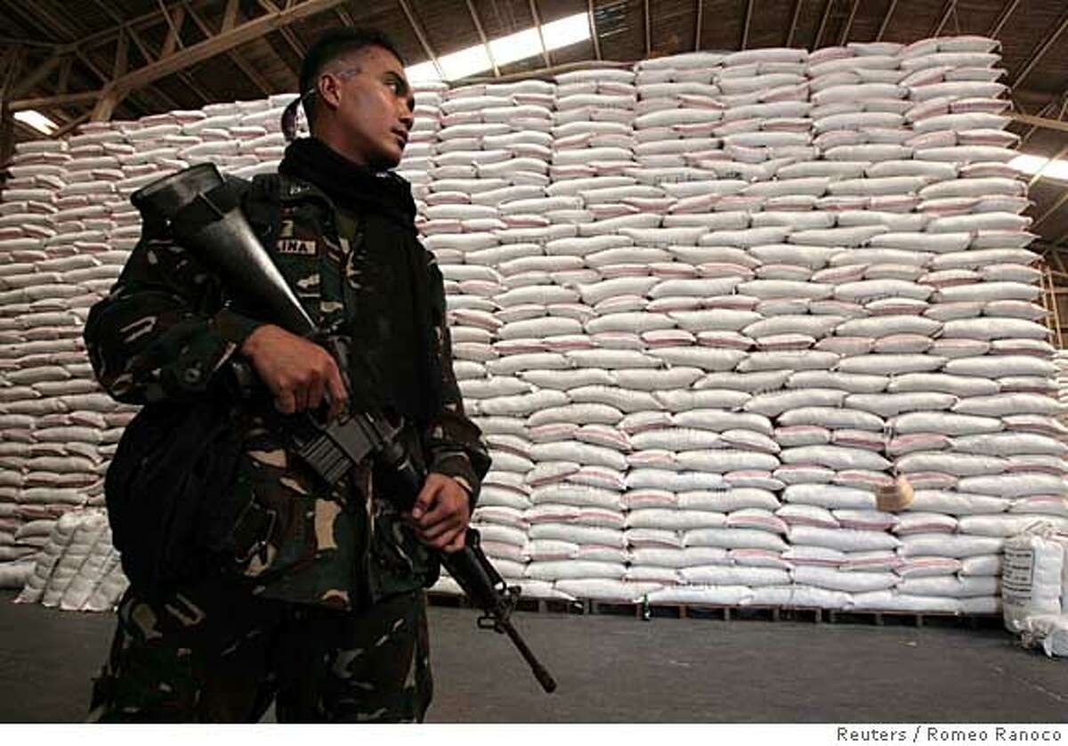 ###Live Caption:A soldier assisting in the delivery and sale of subsidized imported rice sold by the Philippine government to low income groups is seen inside a National Food Authority warehouse in Quezon City, Metro Manila April 23, 2008. Some consumers in Asia are eating less rice or scrimping on already meagre budgets to ensure they can still feed their families a daily helping of the cereal. REUTERS/Romeo Ranoco (PHILIPPINES)###Caption History:A soldier assisting in the delivery and sale of subsidized imported rice sold by the Philippine government to low income groups is seen inside a National Food Authority warehouse in Quezon City, Metro Manila April 23, 2008. Some consumers in Asia are eating less rice or scrimping on already meagre budgets to ensure they can still feed their families a daily helping of the cereal. REUTERS/Romeo Ranoco (PHILIPPINES) Ran on: 04-25-2008 A soldier helps in the delivery and sale of subsidized imported rice sold by the Philippine government to low-income groups in Quezon City. Ran on: 04-25-2008###Notes:A soldier assisting in the delivery and sale of subsidized imported rice is seen inside a National Food Authority warehouse in Quezon City###Special Instructions: