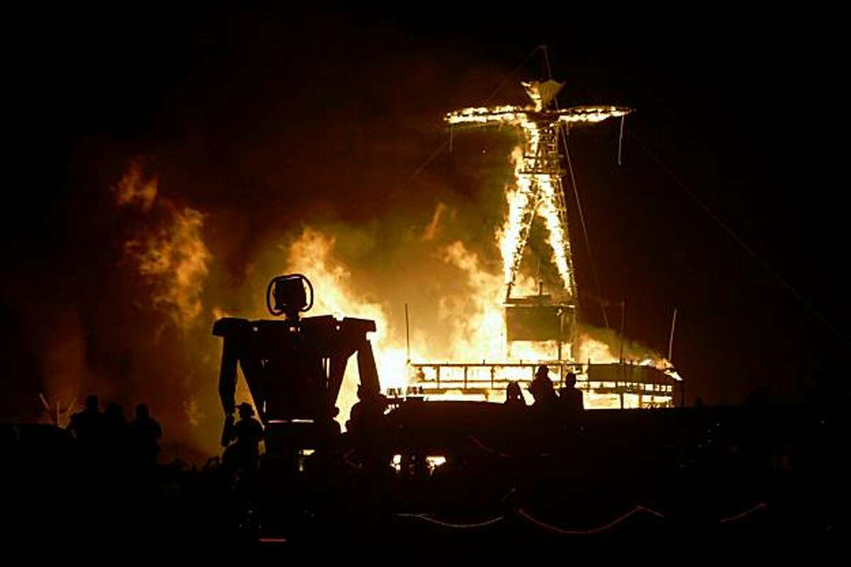 Fireworks and flames marked the burning of the man as thousands watched on the playa Saturday night as the centerpiece of Burning Man 2005, September 3, 2005 in the Black Rock desert.