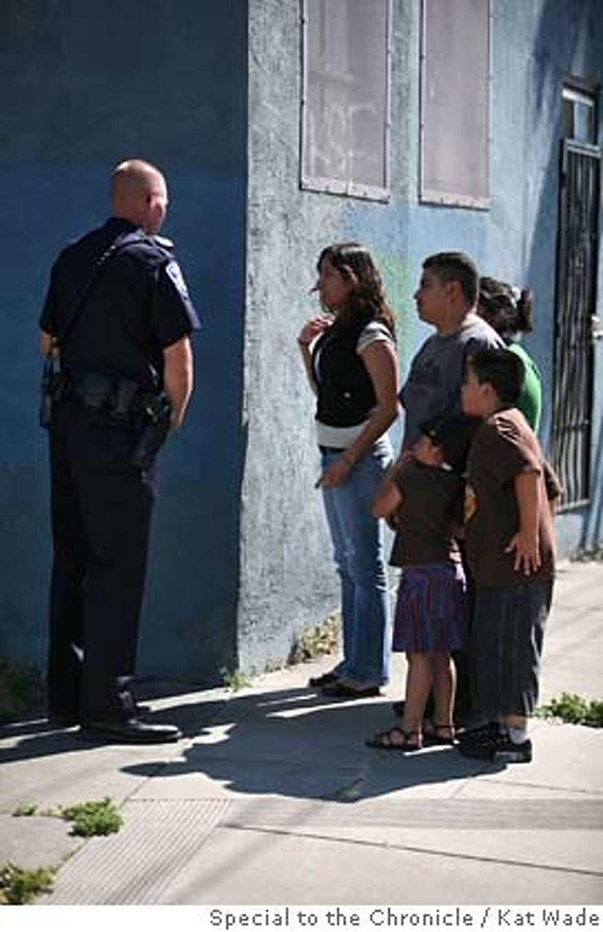###Live Caption:From left, Oakland police officer Frank Petersen, stops Marible Melendez, 14, and her family as they try to go home past the scene where a suspect was killed at 29th Avenue and East 7th Street in Oakland, Calif. on Saturday, April 26, 2008. Photo by Kat Wade / Special to the Chronicle###Caption History:From left, Oakland police officer Frank Petersen, stops Marible Melendez, 14, and her family as they try to go home past the scene where a suspect was killed at 29th Avenue and East 7th Street in Oakland, Calif. on Saturday, April 26, 2008. Photo by Kat Wade / Special to the Chronicle###Notes:Frank Petersen, stops Marible Melendez, 14, (CQ< subjects) The others left before they could give their names I heard that the dead suspect man hijacked a car and had the owner, an old-man in handcuffs.###Special Instructions:Mandatory Credit for photographer and S.F. CHRONICLE/No Sales - mags out