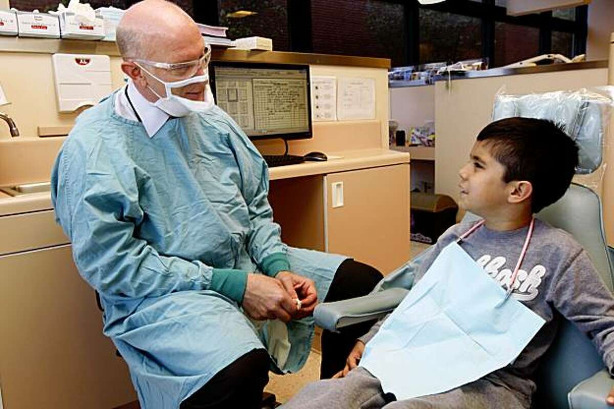 Dr. Jeff Wood (left), professor of the University of the Pacific school of dentistry chatting with Christian Macias, 7 years old, on Tuesday morning, September 8, 2009, at the UOP dental school in San Francisco, Calif.
