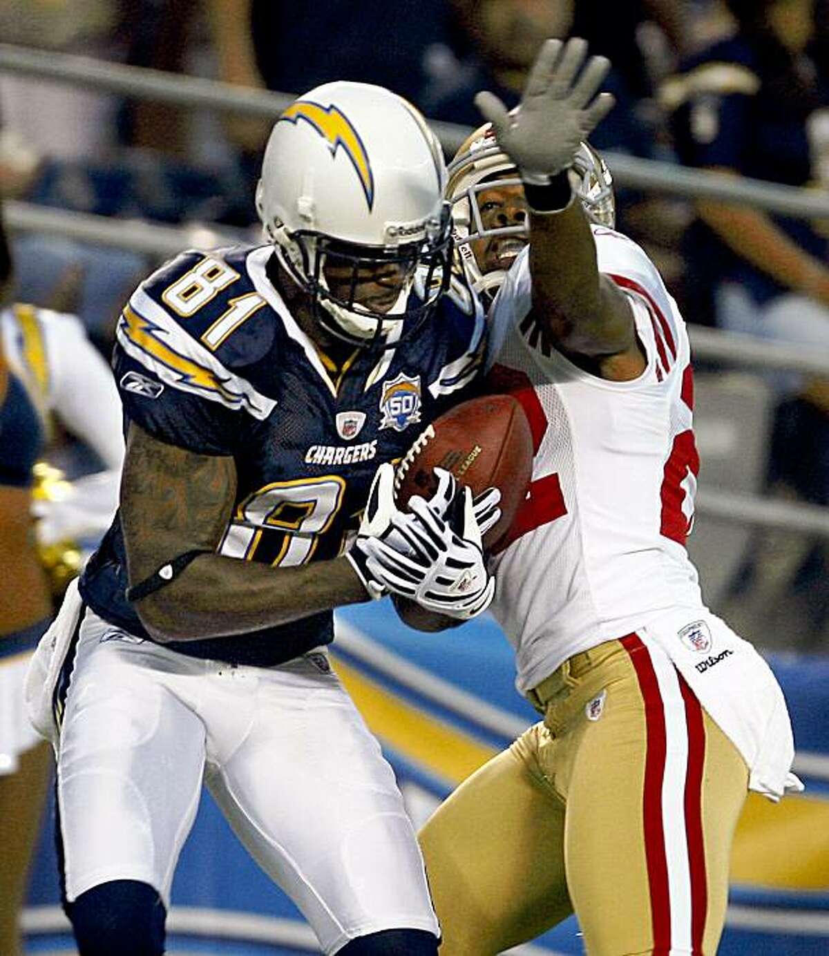 San Diego Chargers wide receiver Kassim Osgood pulls in a 39-yard touchdown pass in front of San Francisco 49ers cornerback Nate Clements during the first quarter of a NFL preseason football game Friday, Sept. 4, 2009 in San Diego. (AP Photo/Lenny Ignelzi)