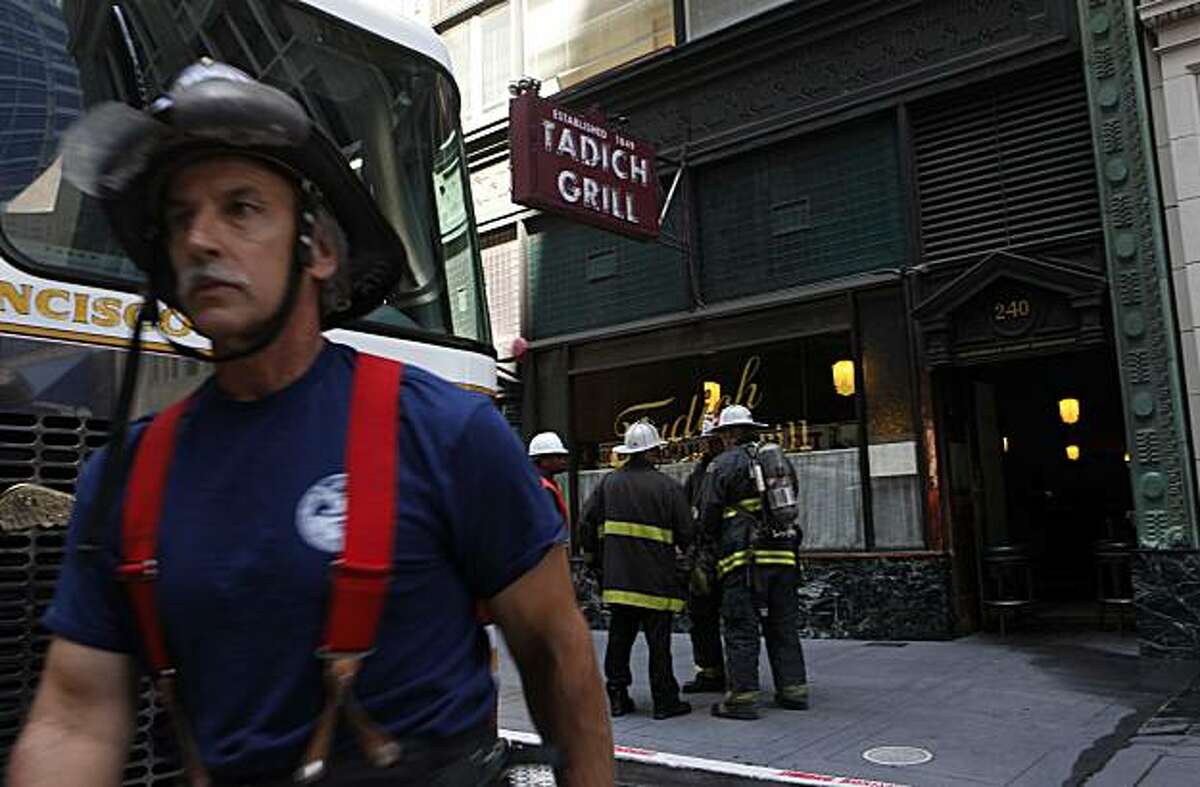 Fire fighters from the San Francisco Fire Department work on a two alarm fire at the historic Tadich Grill in Downtown San Francisco on Monday Aug. 24, 2009. The fire briefly interrupted cable car service on California Street.