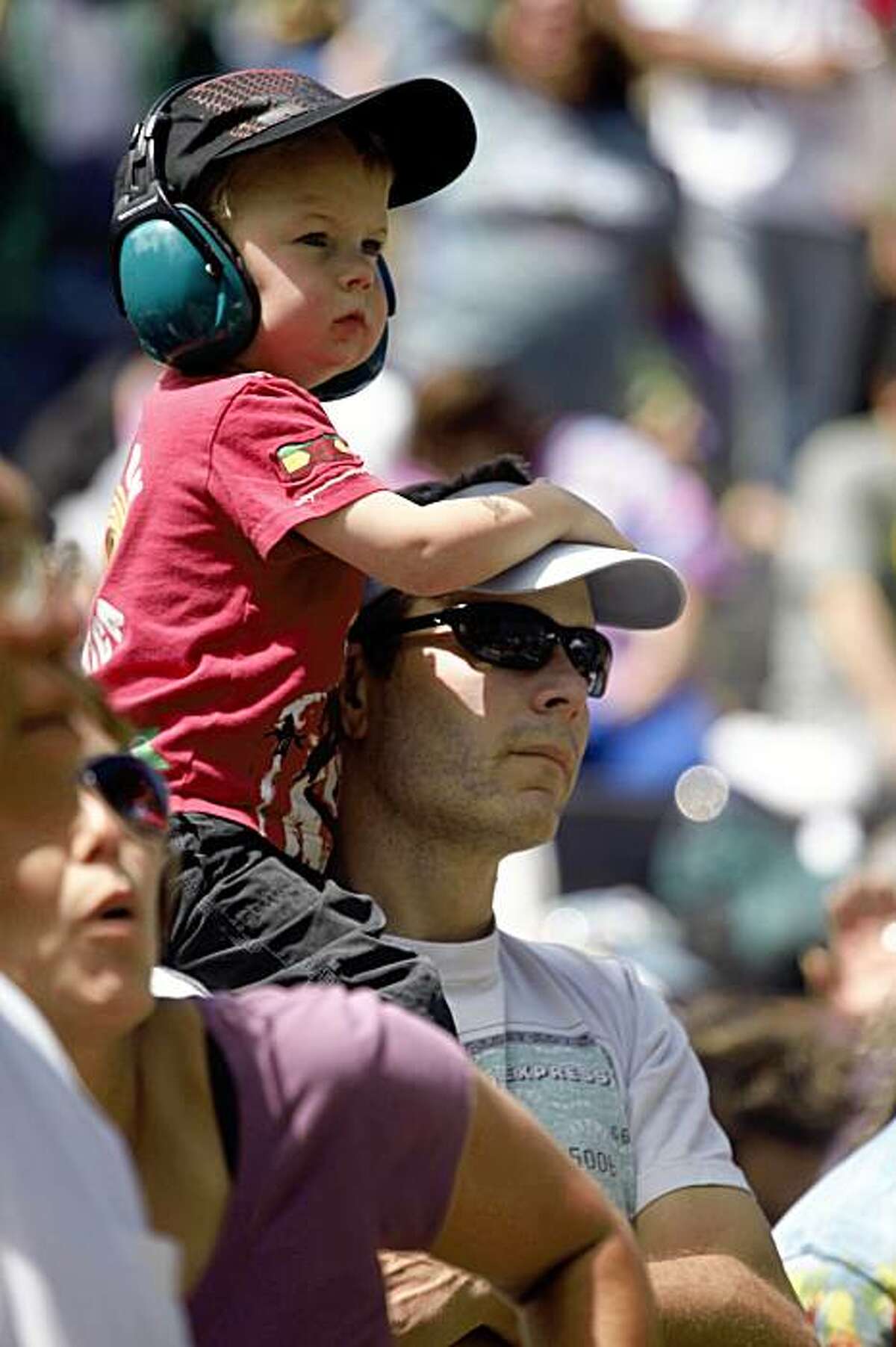 Bruce Lehnert holds his son Lexington Lehnert, 3, both of San Francisco, on his shoulders as they watch Stu Allen and Friends perform at the seventh annual Jerry Day celebration in John McClaren Park on Sunday.