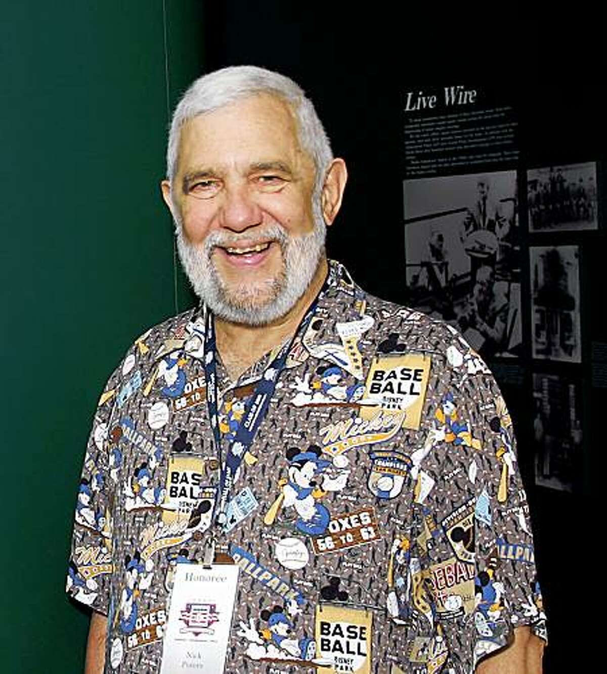 Nick Peters standing in front of the entryway at the Baseball Writers exhibit at the Museum .