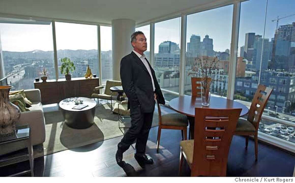 ###Live Caption:One Rincon at 425 first street has its first tenants. Mike Machado standing in the living room of his new condo. He just moved in and loves the views of San Francisco he is one of the first 25 to move in. on March 4,2008. Photo By Kurt Rogers / San Francisco Chronicle###Caption History:One Rincon at 425 first street has its first tenants. Mike Machado standing in the living room of his new condo. He just moved in and loves the views of San Francisco he is one of the first 25 to move in. on March 4,2008. Photo By Kurt Rogers / San Francisco Chronicle###Notes:One rincon 425 first st.###Special Instructions:MANDATORY CREDIT FOR PHOTOG AND SAN FRANCISCO CHRONICLE/NO SALES-MAGS OUT