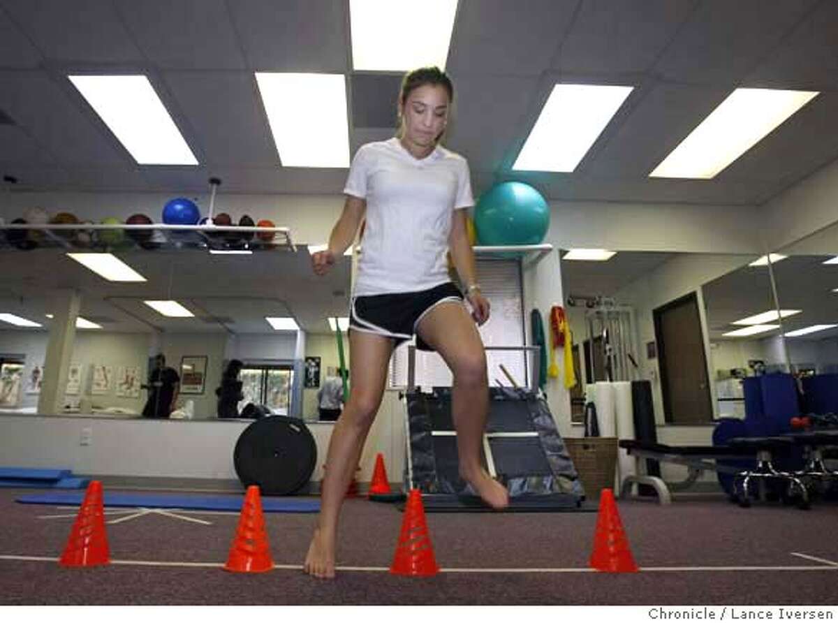 ###Live Caption:Nicole Simon age 15 from Oakland injured both knees, first in Soccer then Basketball that required surgery performs lateral cone drills to help strengthen her knees. Simon is now enrolled in a physical Therapy program with Bruce Valentine a certified Athletic Trainer at the new Sports Medicine Center for Young Athletes at Children's Hospital. Photo taken on Thursday March 6, 2008. Photo by Lance Iversen / San Francisco Chronicle###Caption History:Nicole Simon age 15 from Oakland injured both knees, first in Soccer then Basketball that required surgery performs lateral cone drills to help strengthen her knees. Simon is now enrolled in a physical Therapy program with Bruce Valentine a certified Athletic Trainer at the new Sports Medicine Center for Young Athletes at Children's Hospital. Photo taken on Thursday March 6, 2008. Photo by Lance Iversen / San Francisco Chronicle###Notes:Lance Iversen 415-2979395###Special Instructions:MANDATORY CREDIT PHOTOG AND SAN FRANCISCO CHRONICLE.