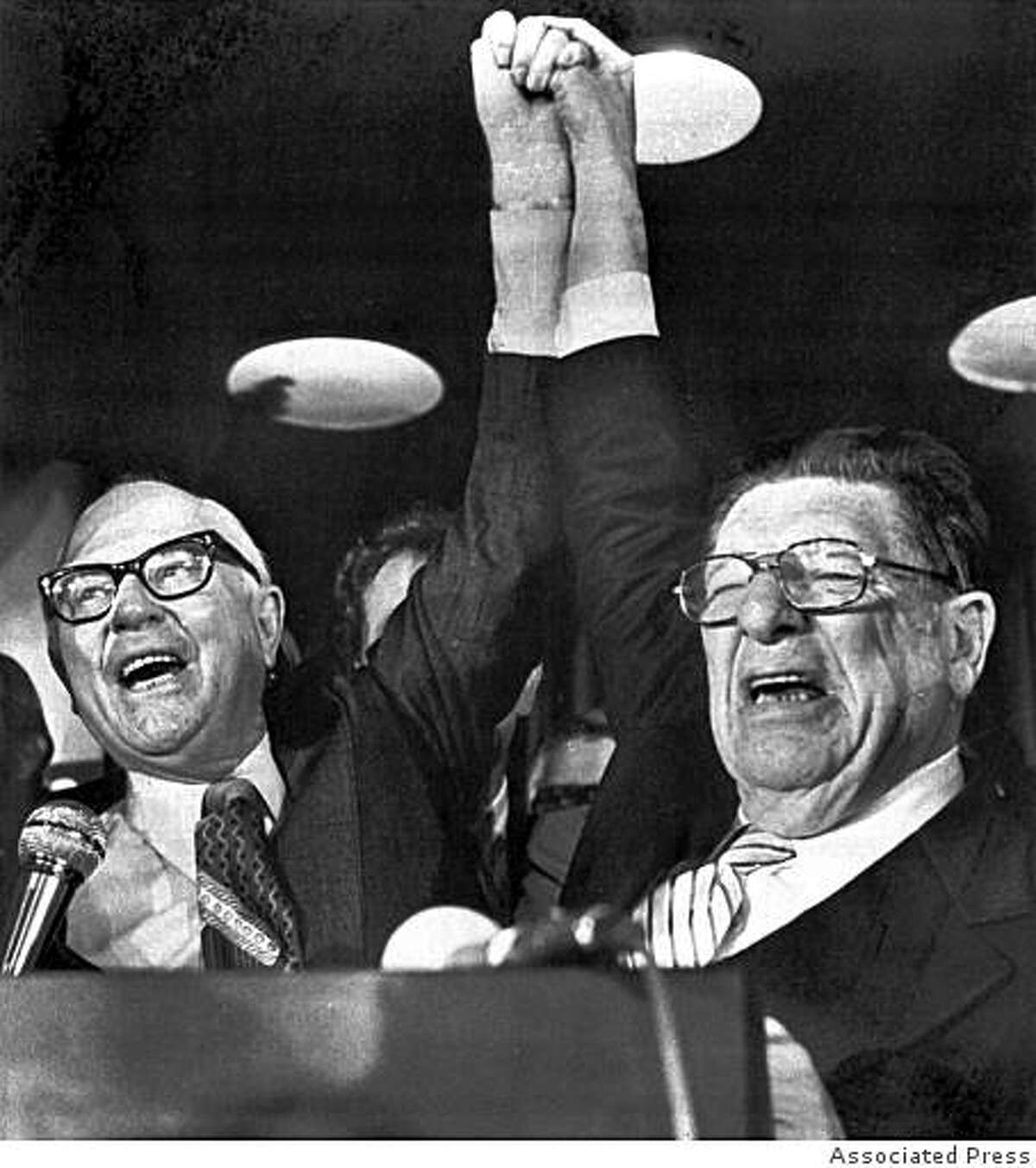Paul Gann, left, and Howard Jarvis, hold up their hands on the night of June 7, 1978, as their co-authored initiative Proposition 13, took a commanding lead in the California primary.The Proposition provides monumental tax relief to peroperty owners. (AP Photo/stf)
