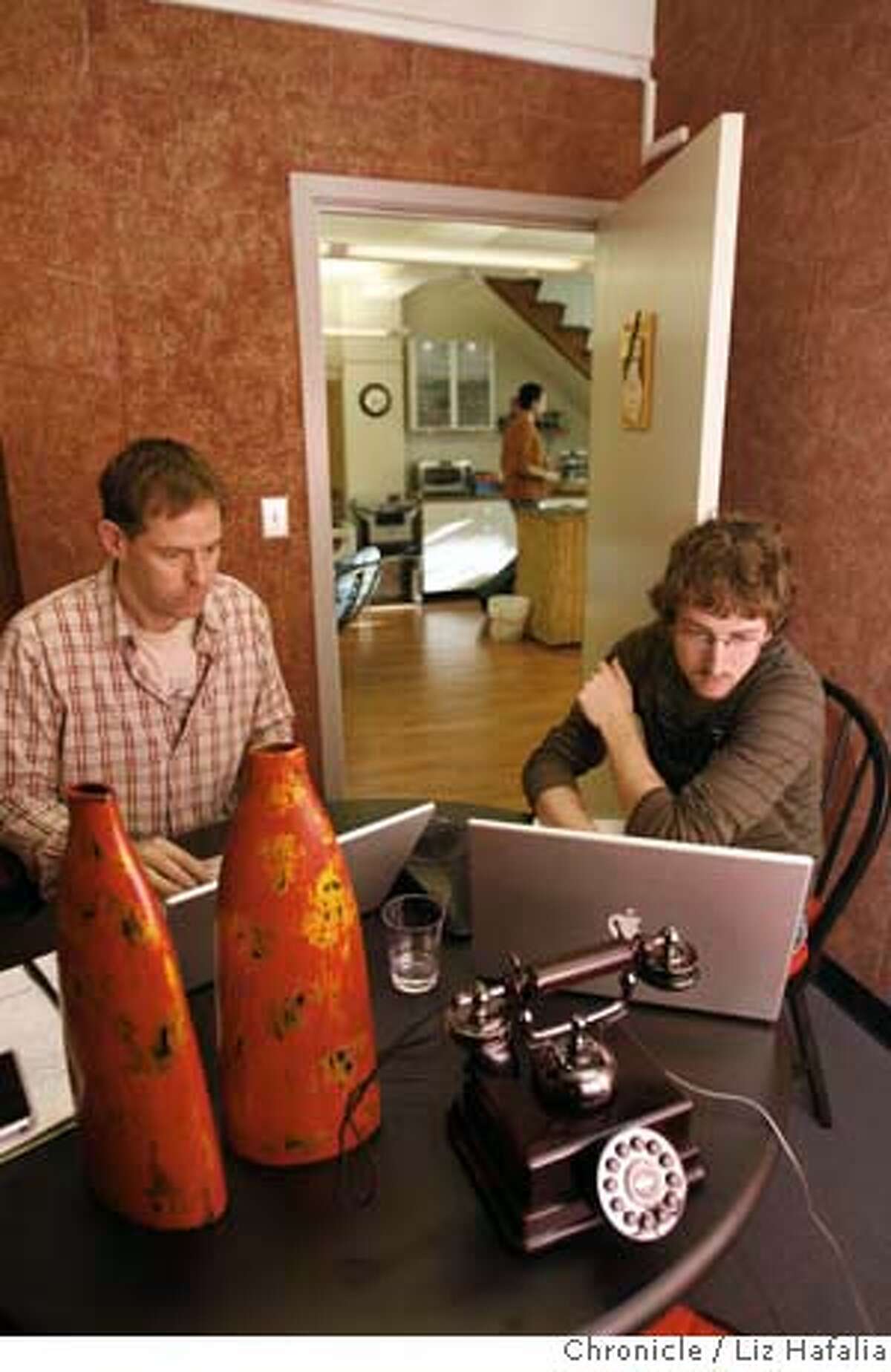 James Nicholson and David Pascual in the telephone room of Sandbox Suites, a co-working space. Photo by Liz Hafalia/San Francisco Chronicle Ran on: 02-19-2008 James Nicholson and David Pascual work in the telephone room of Sandbox Suites in San Francisco. It is one of a number of communal spaces that offer work areas to people without their own offices.