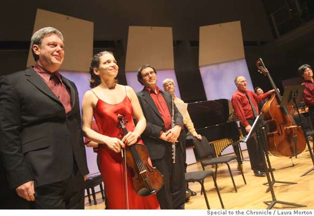 Conductor David Milnes (left) and violinist Carla Kihlstedt take a bow with the rest of the ensemble after presenting the world premier of Jorge Liderman's piece Furthermore at the Yerba Buena Center for the Arts Forum on Monday night. (Laura Morton/Special to the Chronicle) Ran on: 02-06-2008 Conductor David Milnes (left), violinist Carla Kihlstedt and other musicians at the premiere of Jorge Lidermans Furthermore{hellip}