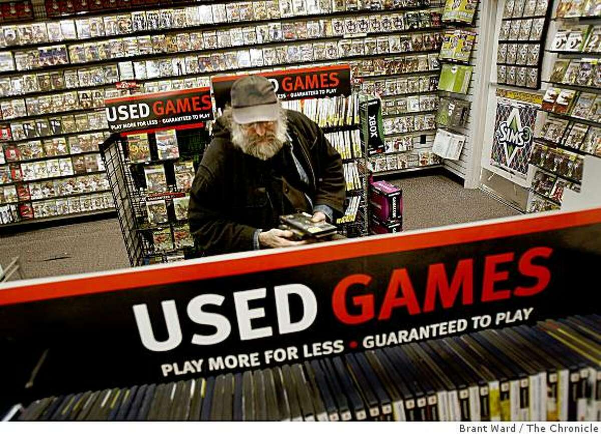 Neil Taylor of San Francisco loves games and purchased several used products at the Gamestop in San Francisco, Calif., on June 2, 2009. Used games, sold at a discount at retailers like Gamestop are a boon to consumers. Game publishers argue they don't see any profit from the resale of their product.