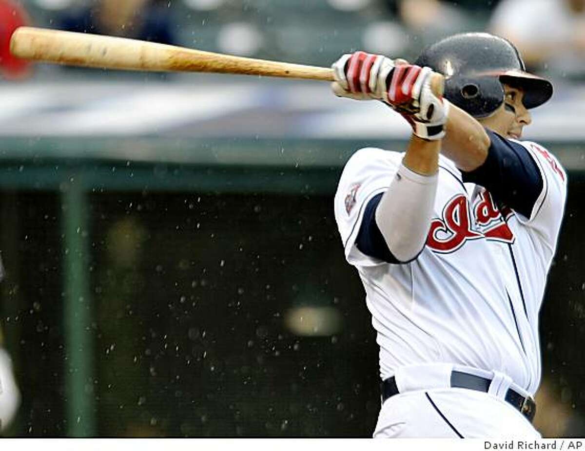 Cleveland Indians Victor Martinez lines an RBI-single to score teammmate Kelly Shoppach in the fifth inning of a baseball game against the Tampa Bay Rays on Thursday, May 28, 2009, in the rain at Progressive Field in Cleveland, Ohio. (AP Photo/David Richard)