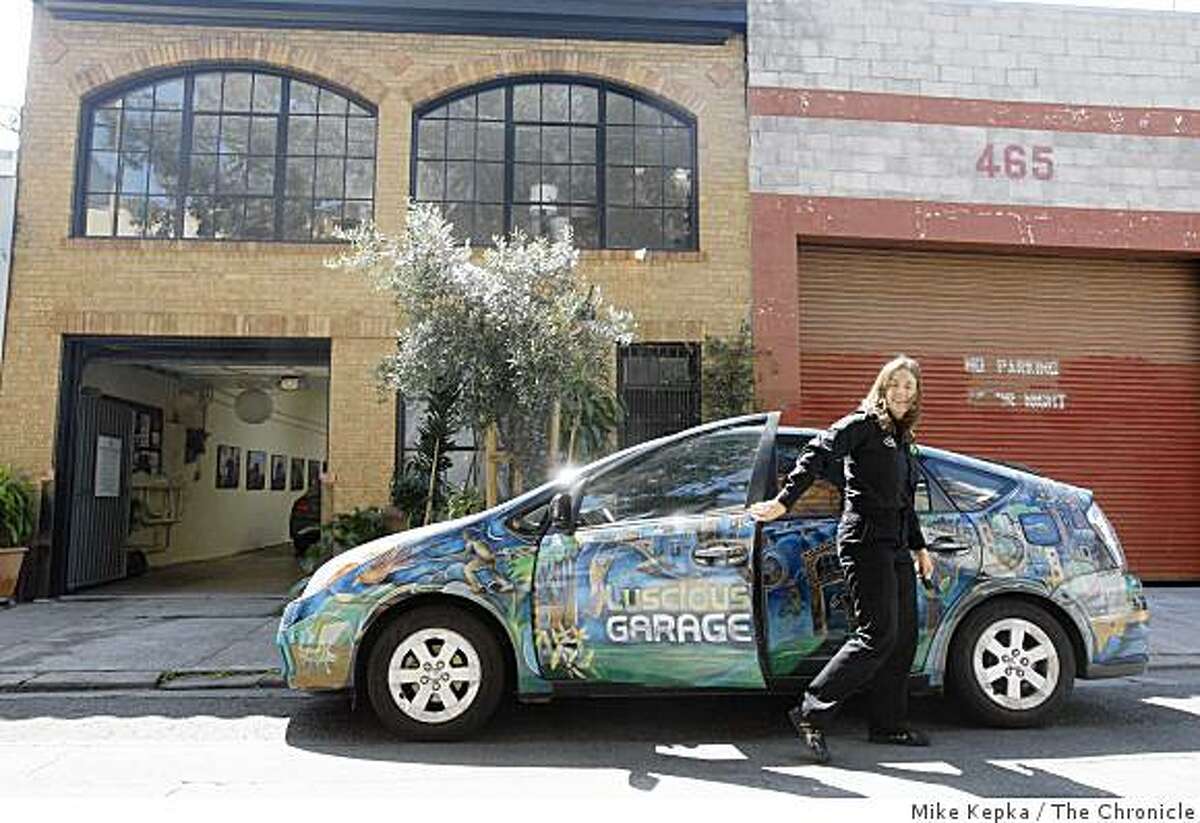 Carolyn Coquillette, owner and lead technition Luscious Garage, a SOMA auto repair garage that was the first in the nation to fully specialize on servicing hybrid electric-gas powered vehicles like the Prius when it opened less than two years ago, pulls into work in her customized Prius on Monday May 19, 2009 in San Francisco, Calif.