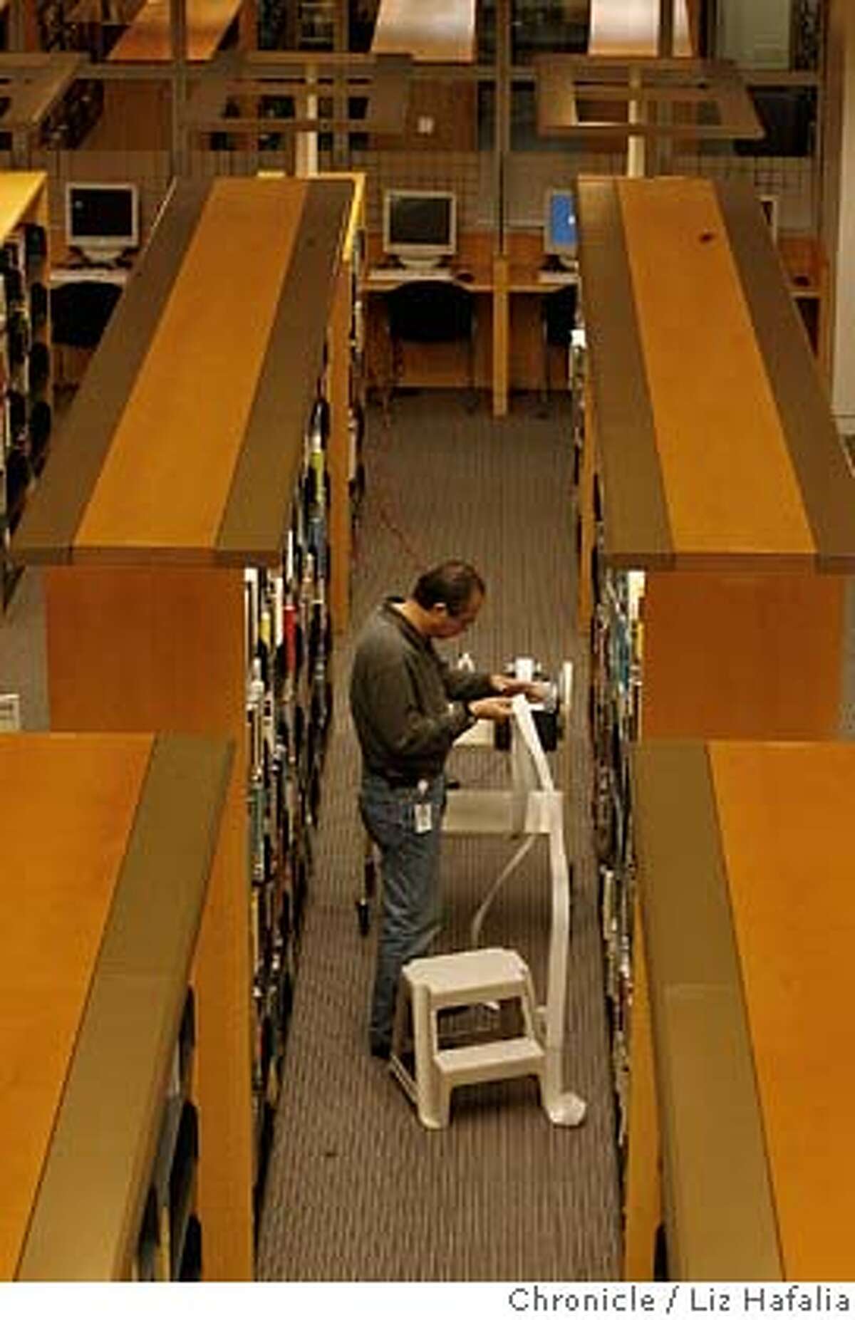 Librarian is barcoding books in the new fiction section of the first floor which will have it's opening on Wed. Jan 16. �2007, San Francisco Chronicle/ Liz Hafalia MANDATORY CREDIT FOR PHOTOG AND SAN FRANCISCO CHRONICLE. NO SALES- MAGS OUT.