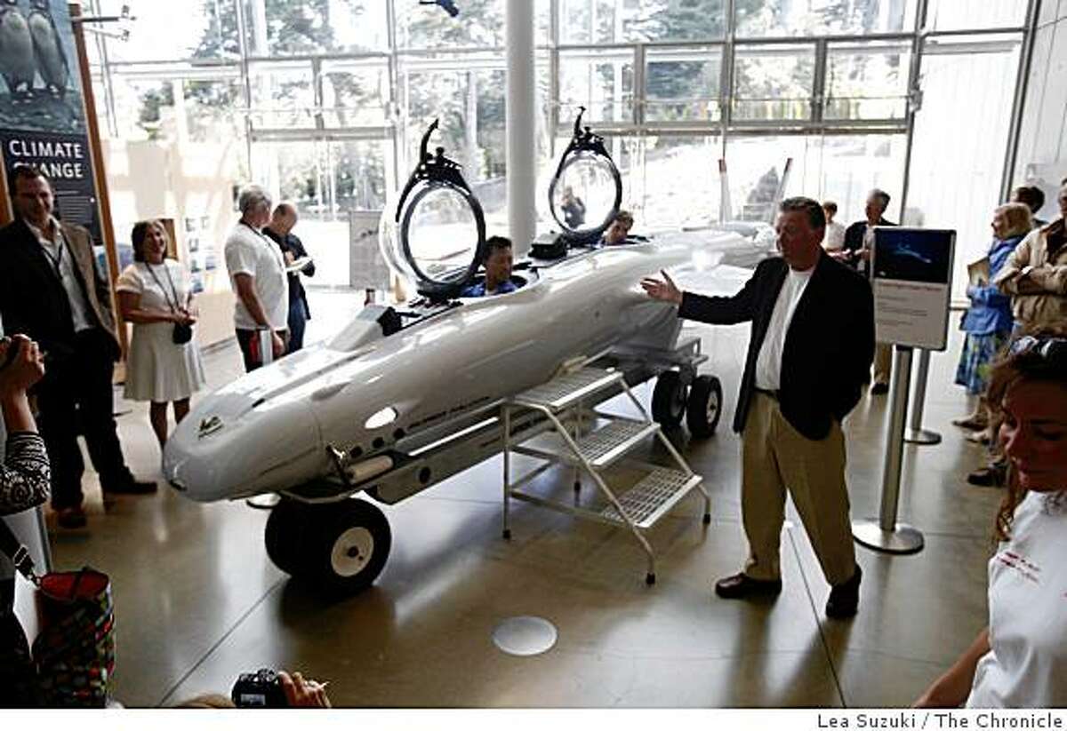 Graham Hawkes (right in dark jacket) designed and built a sub capable of reaching record depths called Deep Flight Super Falcon and unveiled it at the California Academy of Sciences on Wednesday May 13, 2009 in San Francisco, Calif.