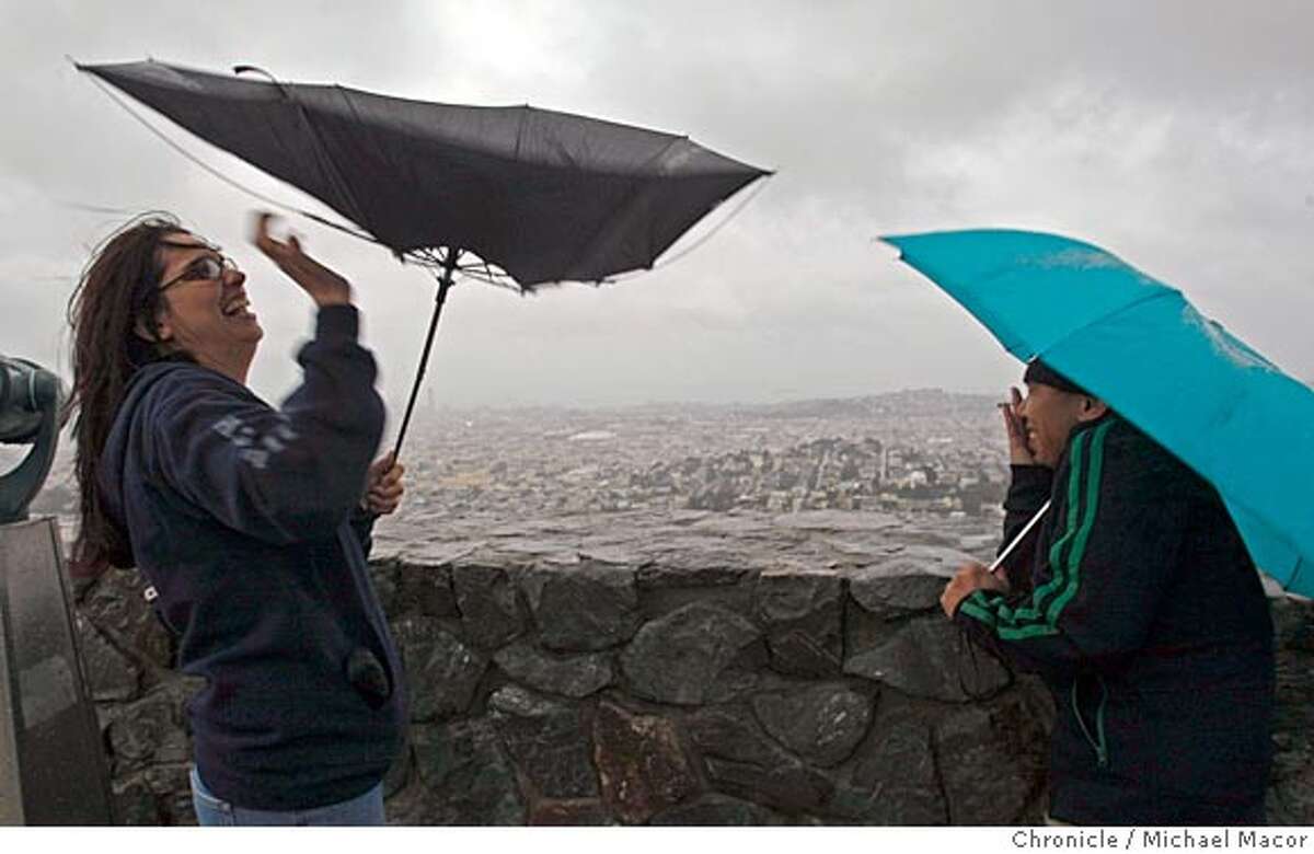 rain_082_mac.jpg Gloria Hughes of Reno, Nv., (left) struggles with her umbrella while visiting the Twin Peaks vistors area above downtown San Francsico. Her friend Joel Ocray, are on a mini road trip between Reno and San Francsico. The first of three large storms moves into the Bay Area this morning. Photo by: Michael Macor / The Chronicle Taken on 1/3/08, in San Francisco, CA, USA Ran on: 01-04-2008 Gloria Hughes of Reno struggles with her umbrella as it turns inside out in the wild wind and rain on Twin Peaks while friend Joel Ocray hangs onto his brolly. Ran on: 01-04-2008 Gloria Hughes of Reno struggles with her umbrella as it turns inside out in the wild wind and rain on Twin Peaks while friend Joel Ocray hangs onto his brolly.
