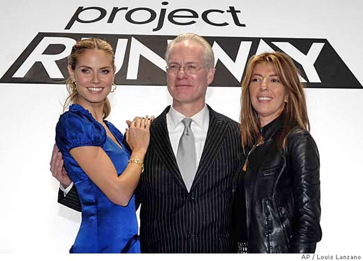 Panelists supermodel Heidi Klum, left, Tim Gunn and Nina Garcia pose for photographers following the presentation of fashions by fifteen designers competing for the top designer award on the "Project Runway" TV reality show, Tuesday, Nov. 6, 2007, in New York. (AP Photo/Louis Lanzano)